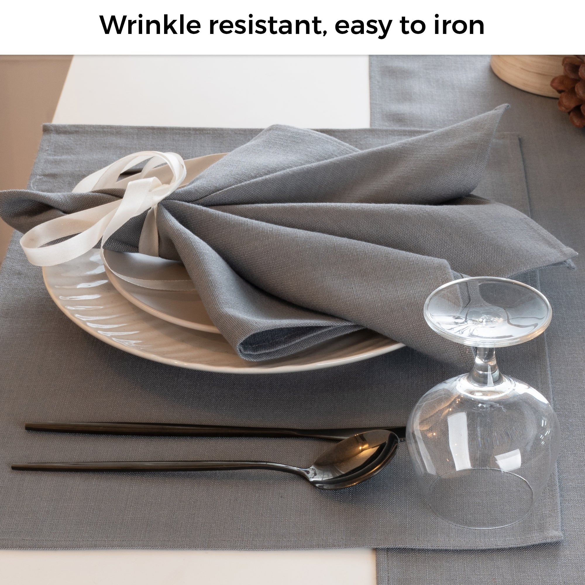 Charcoal grey faux linen placemats folded to show fabric texture