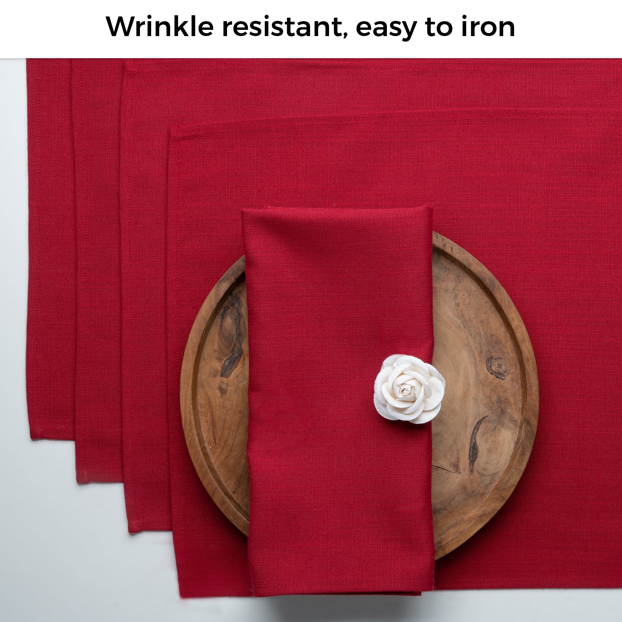 Red faux linen placemats folded to show fabric texture