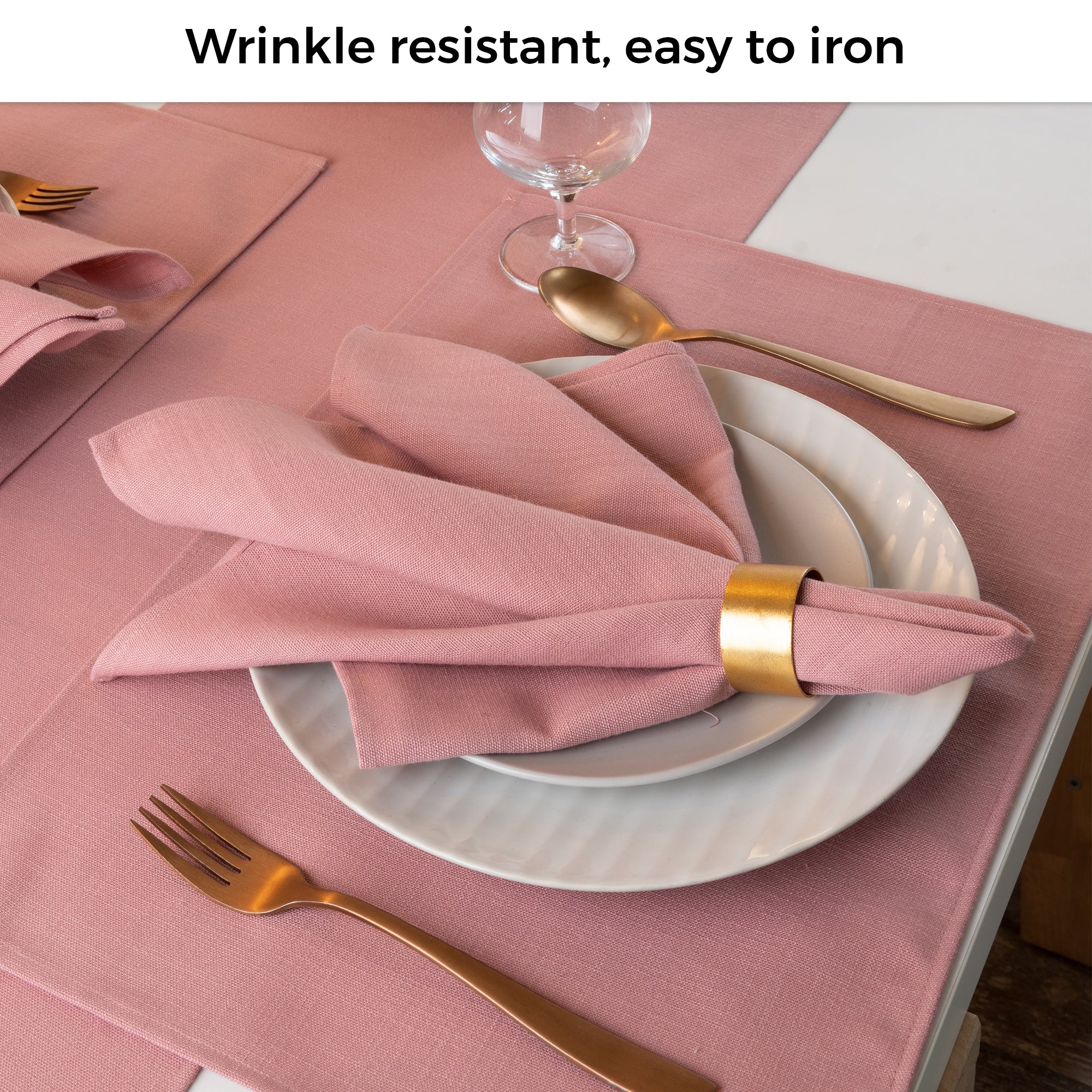 Dusty pink faux linen placemats folded to show fabric texture