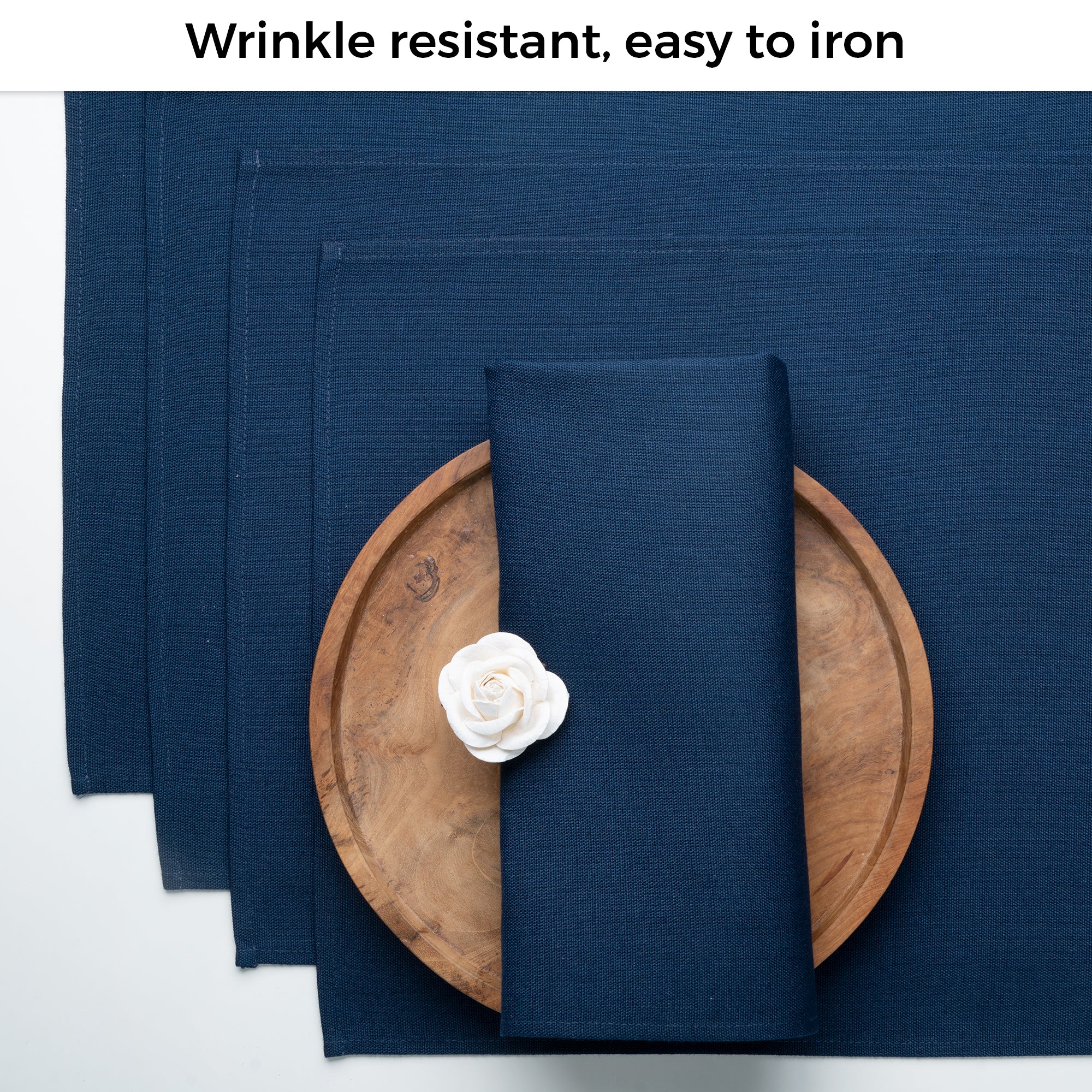 Navy blue faux linen placemats folded to show fabric texture