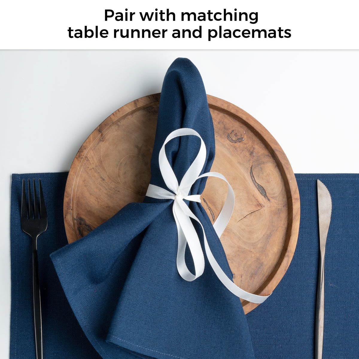 Navy blue faux linen dinner napkins in a set table setting