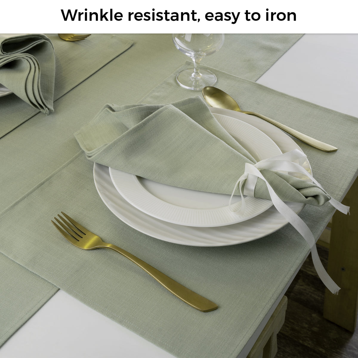Sage green faux linen dinner napkins folded to show fabric texture