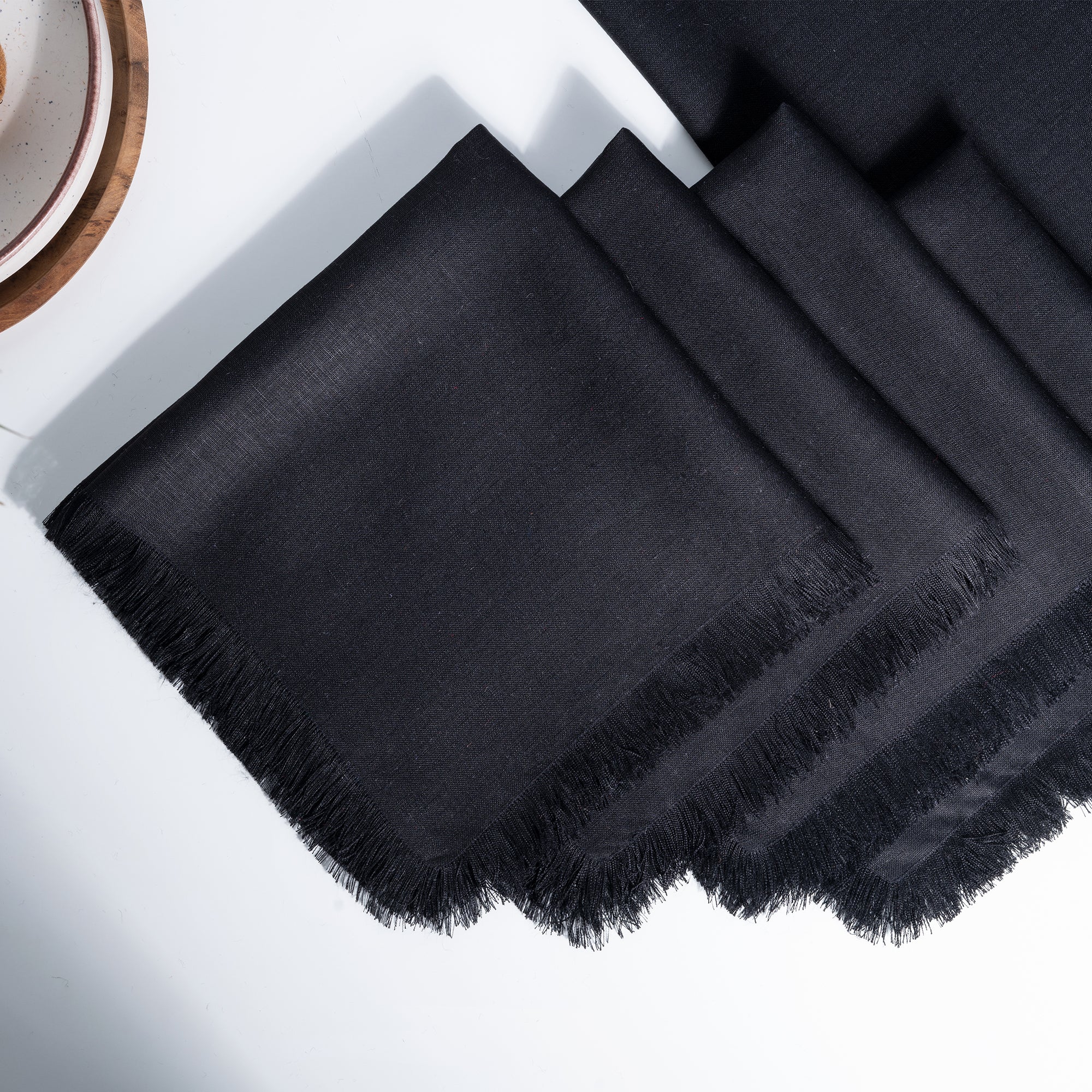 Black pure linen dinner napkins styled on a dining table