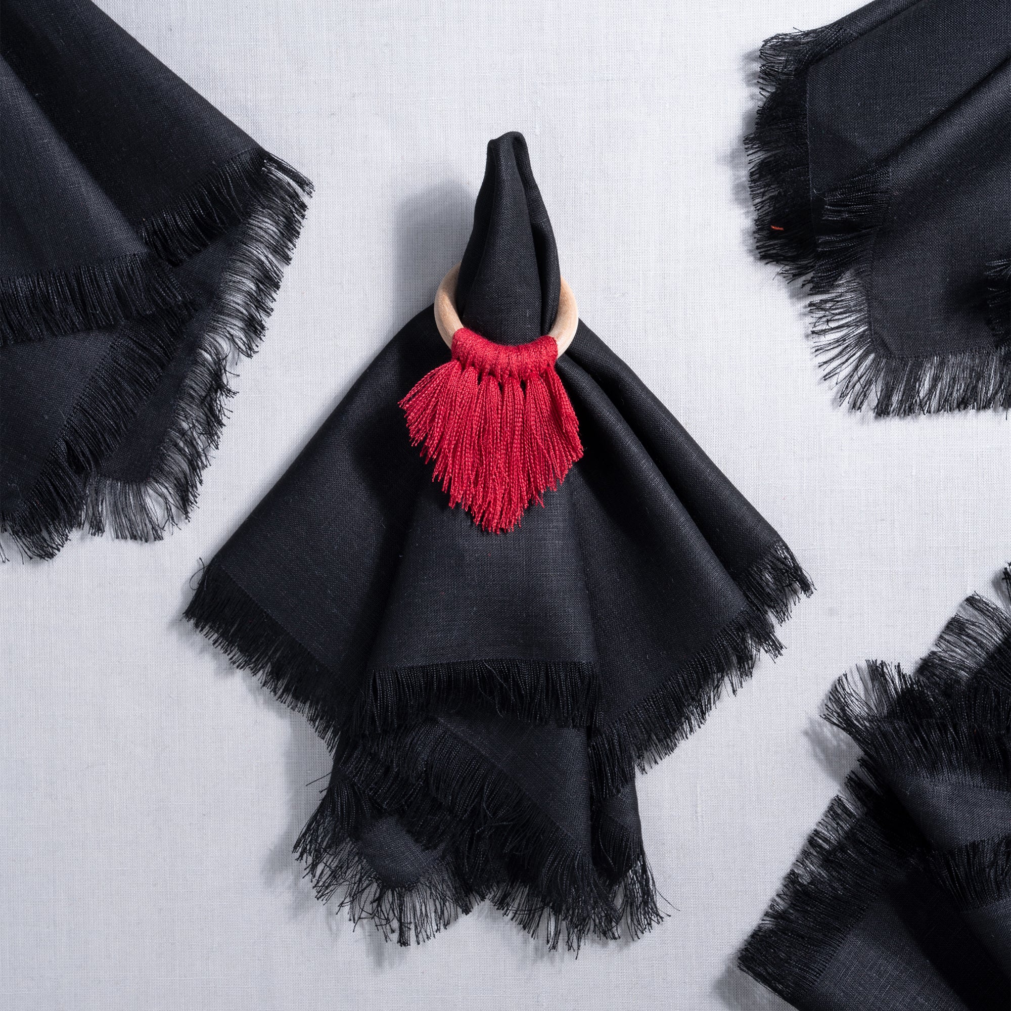Close-up of the fringed edge on black pure linen dinner napkins