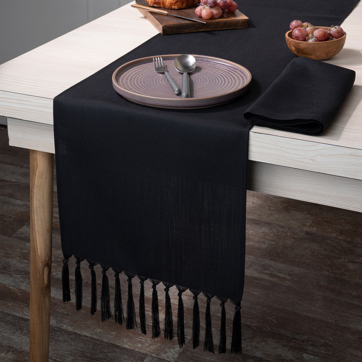 Black faux linen table runner styled on a dining table