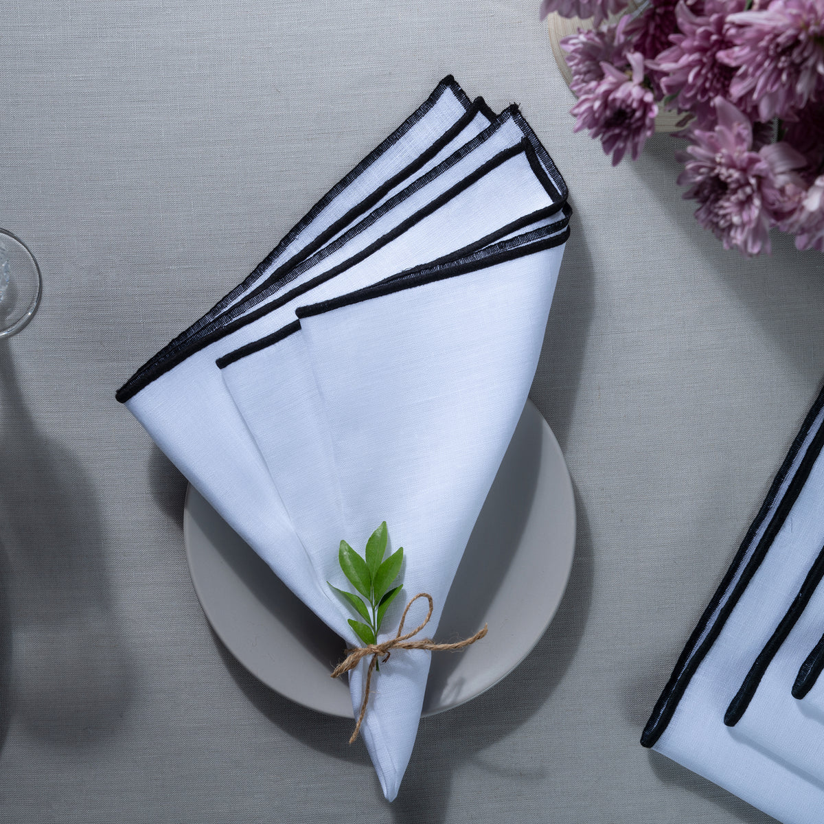 White and black pure linen dinner napkins with matching D'Moksha table linens