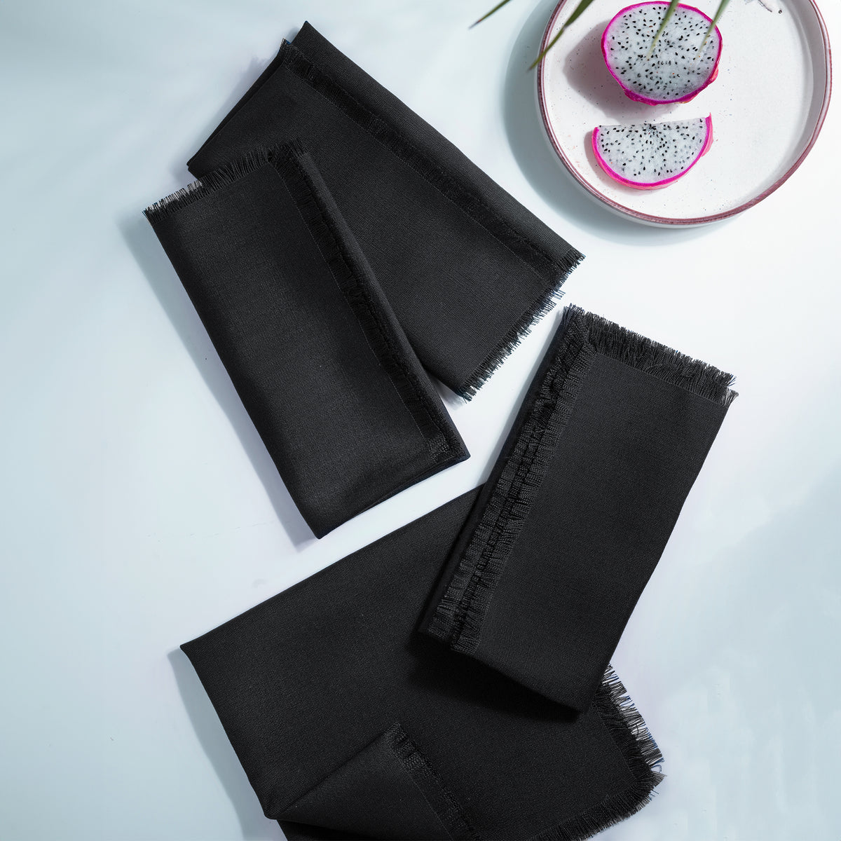 Black faux linen dinner napkins styled on a dining table