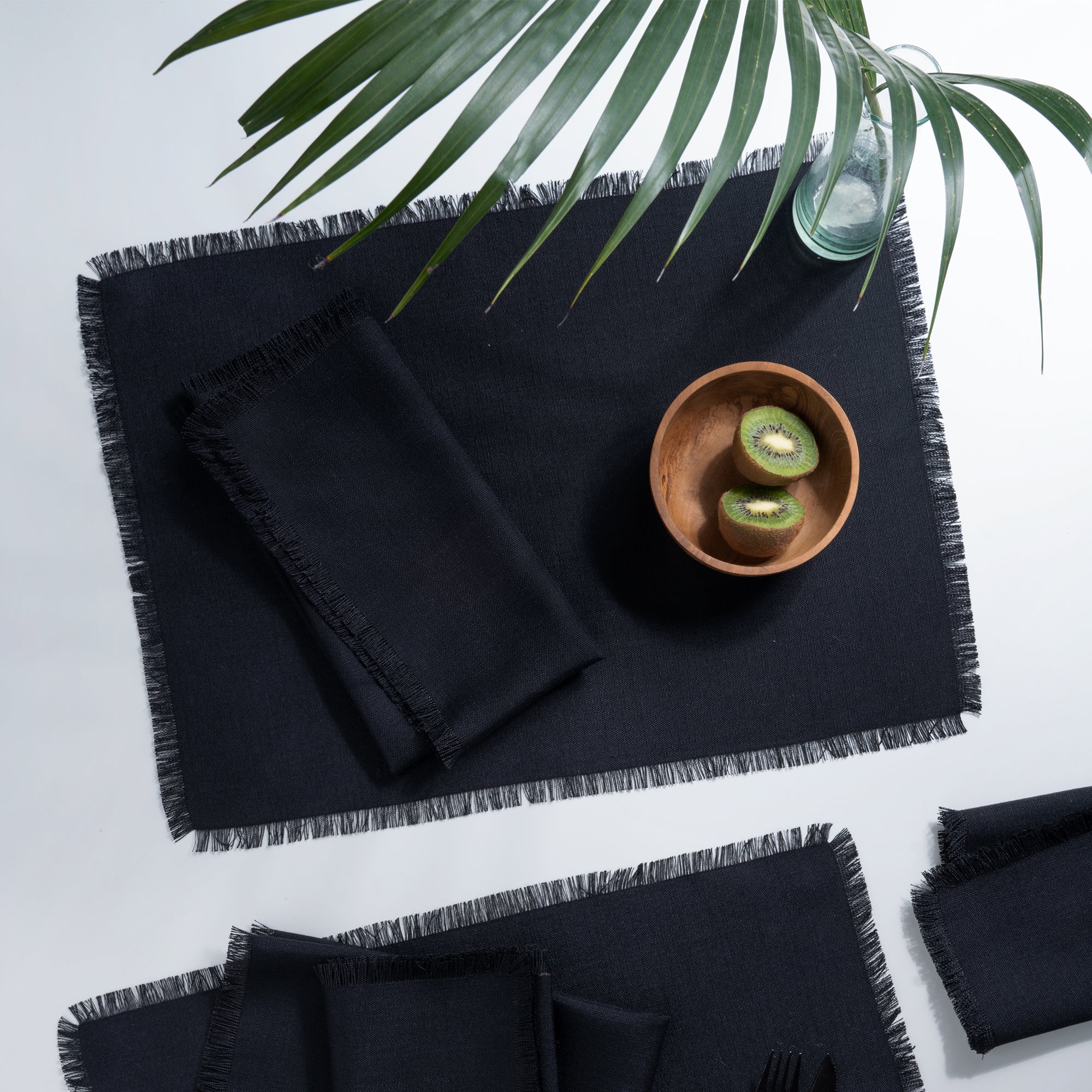 Black faux linen placemats styled on a dining table