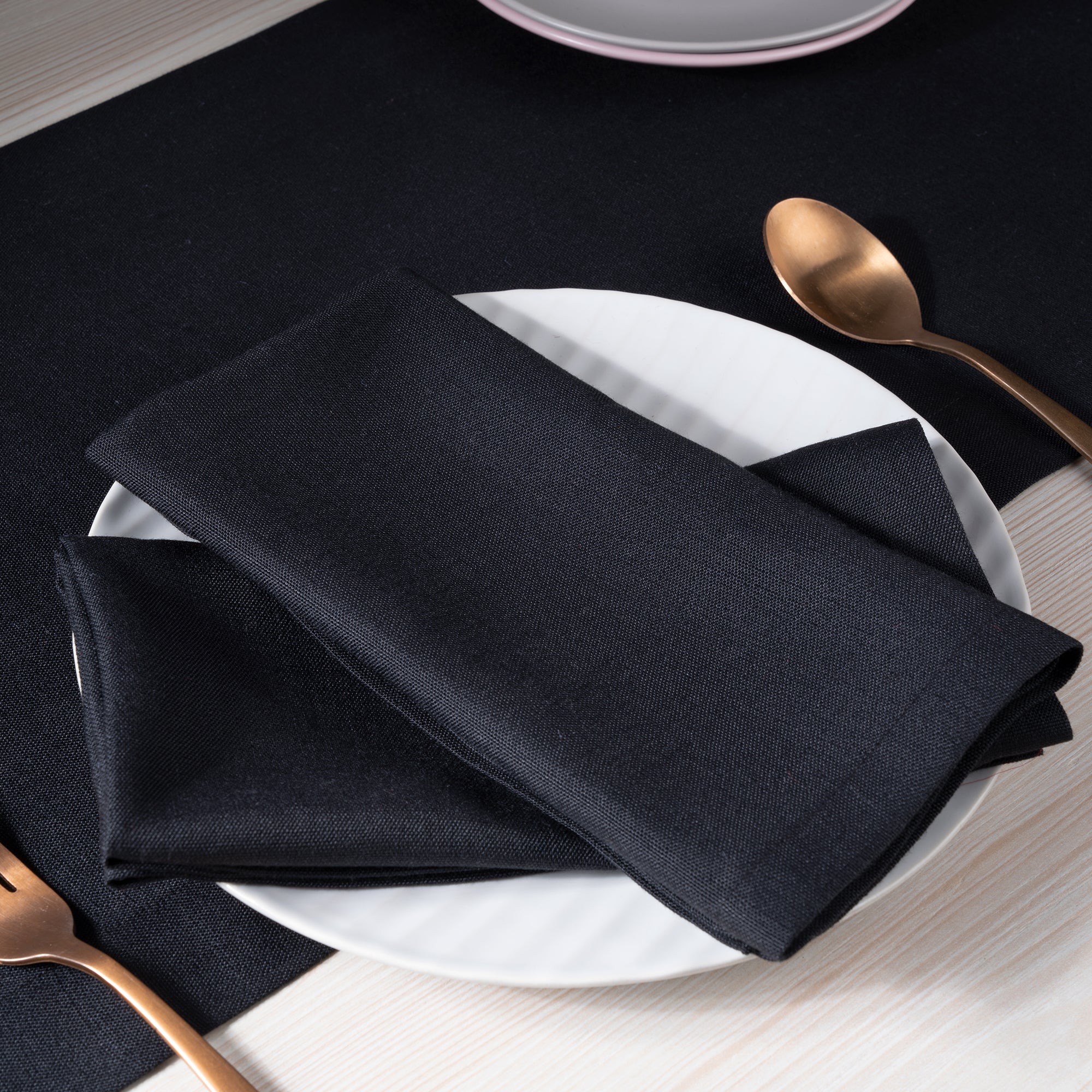 Black faux linen dinner napkins with matching D'Moksha table linens