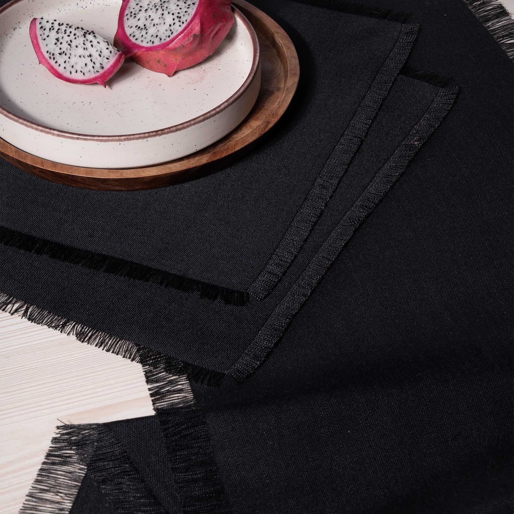 Black faux linen placemats in a set table setting