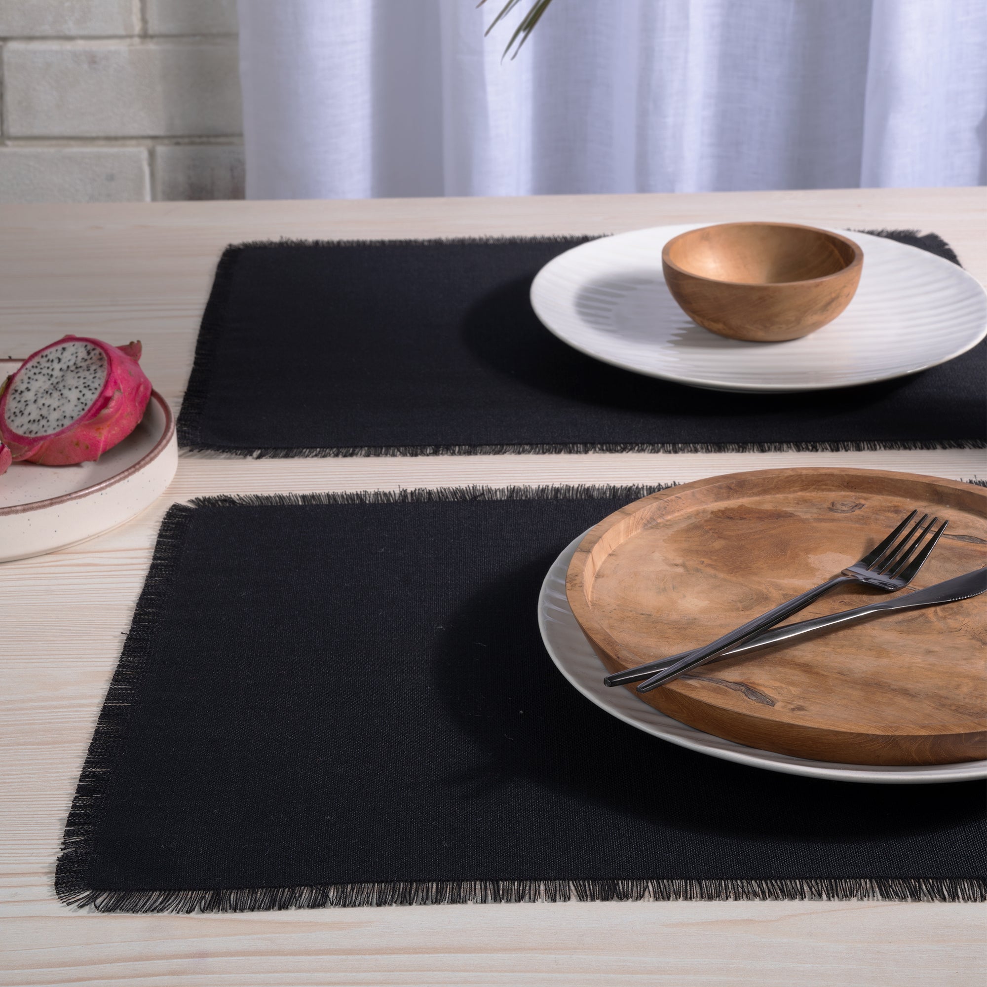 Black faux linen placemats with matching D'Moksha table linens