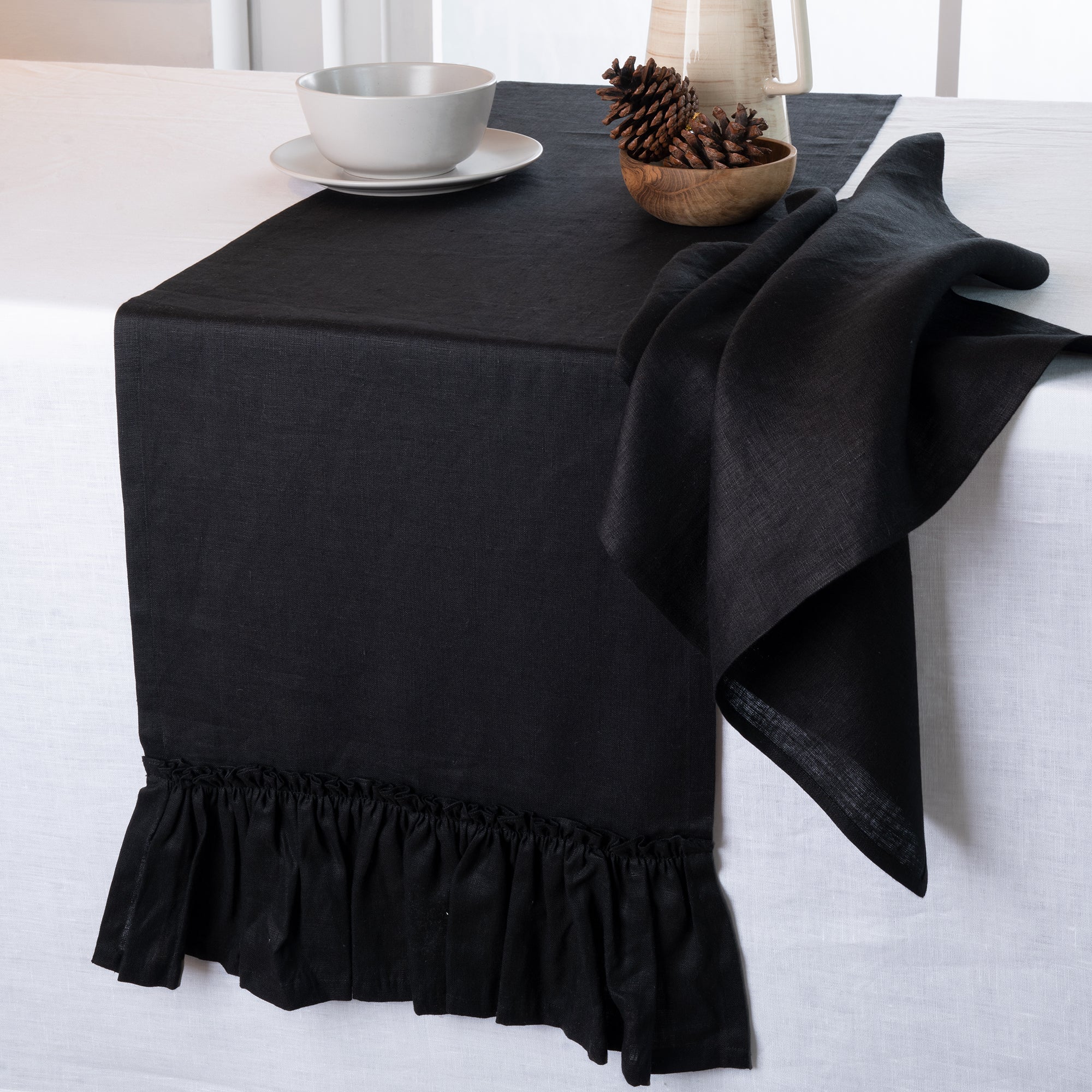 Black pure linen table runner styled on a dining table
