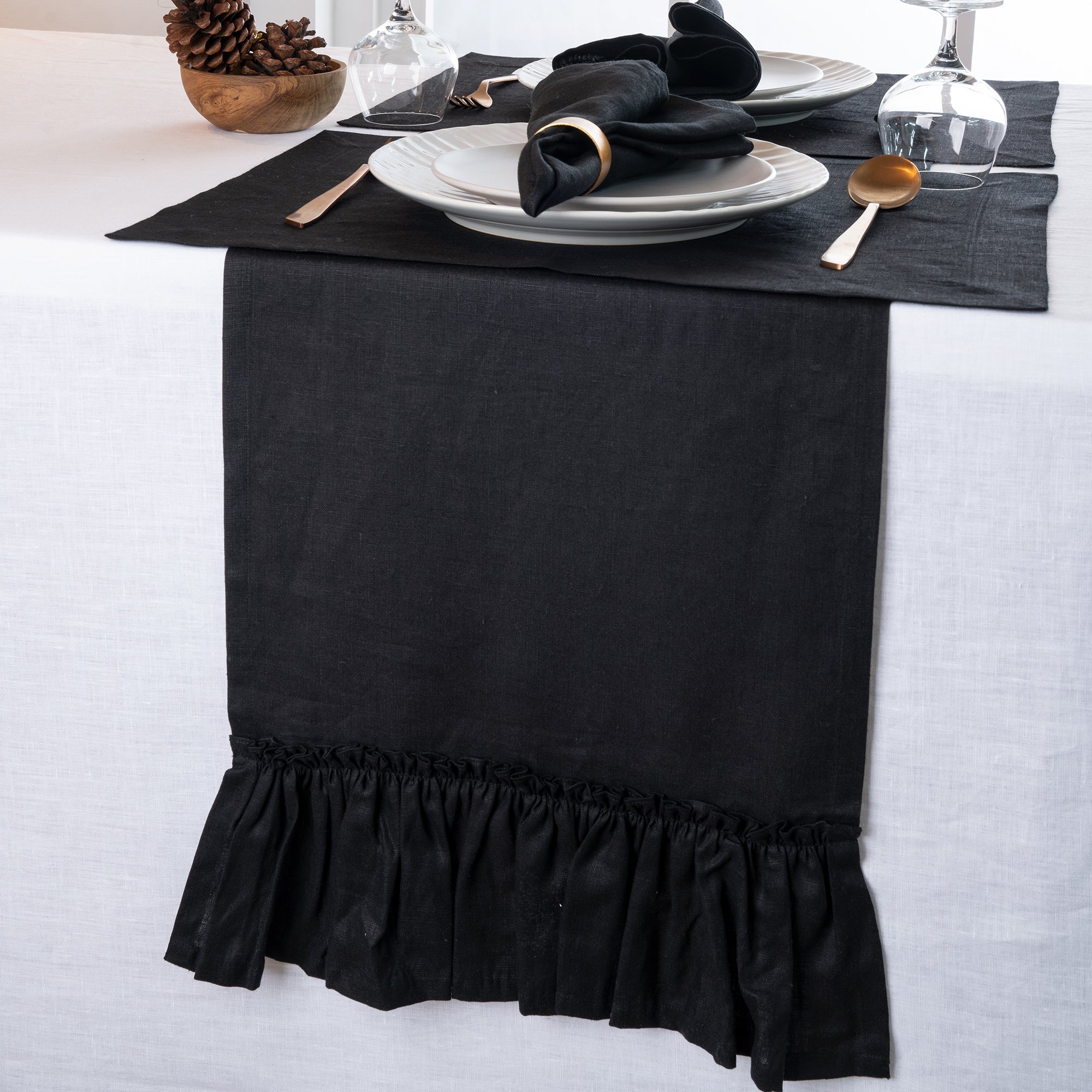 Close-up of the ruffled edge on a black pure linen table runner