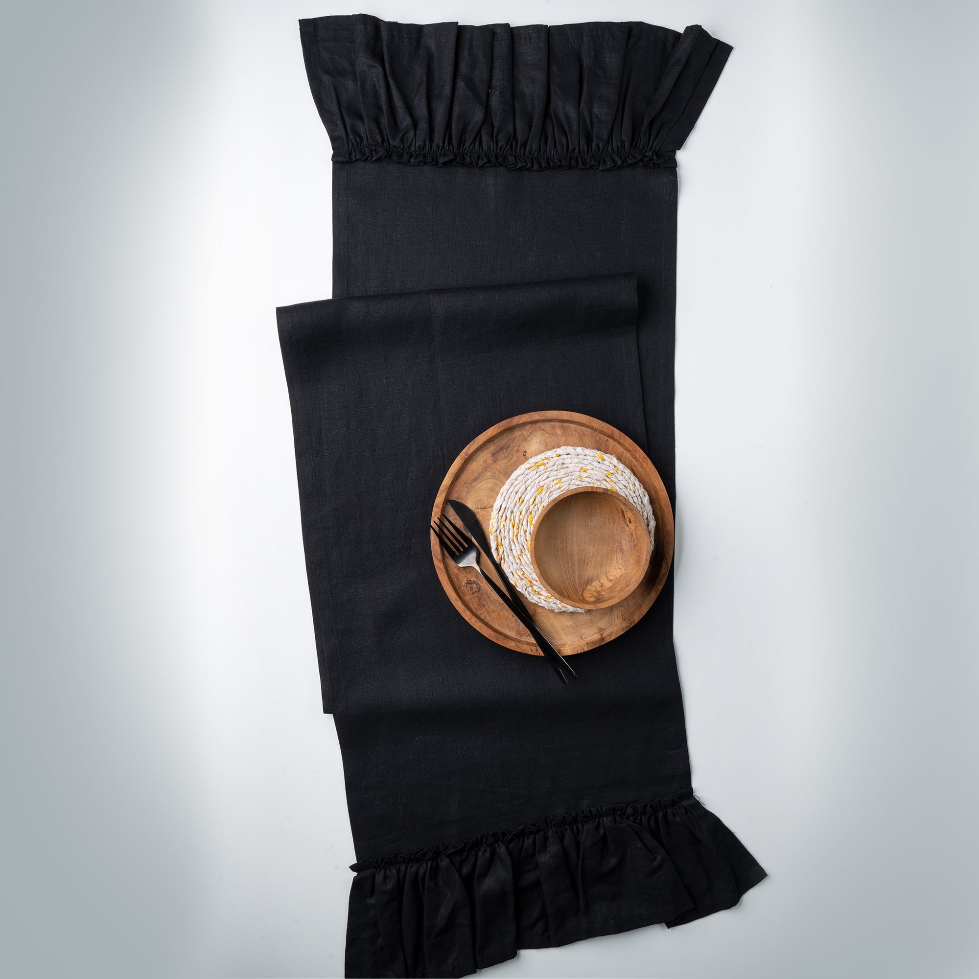 Black pure linen table runner in a set table setting