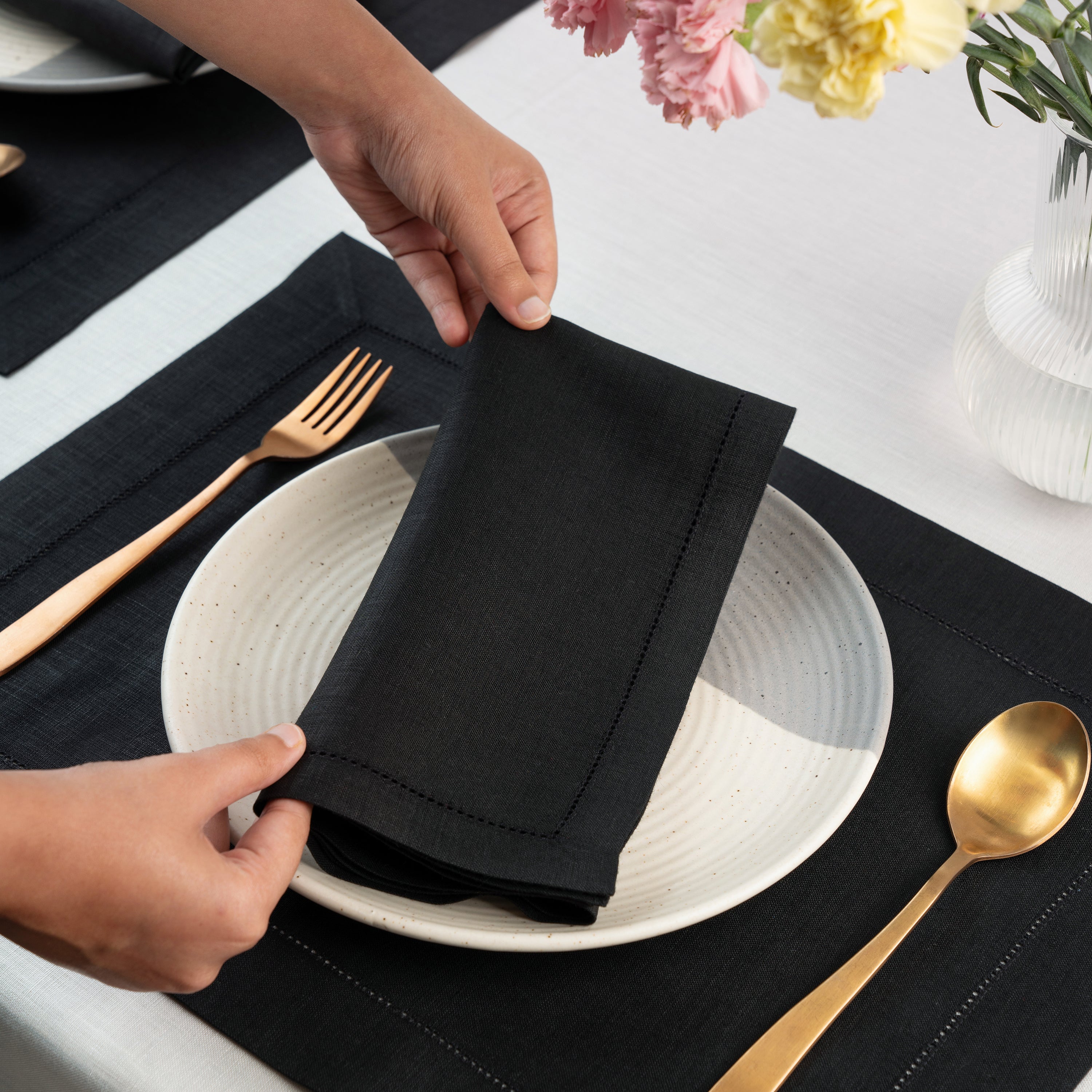 Black pure linen dinner napkins styled on a dining table