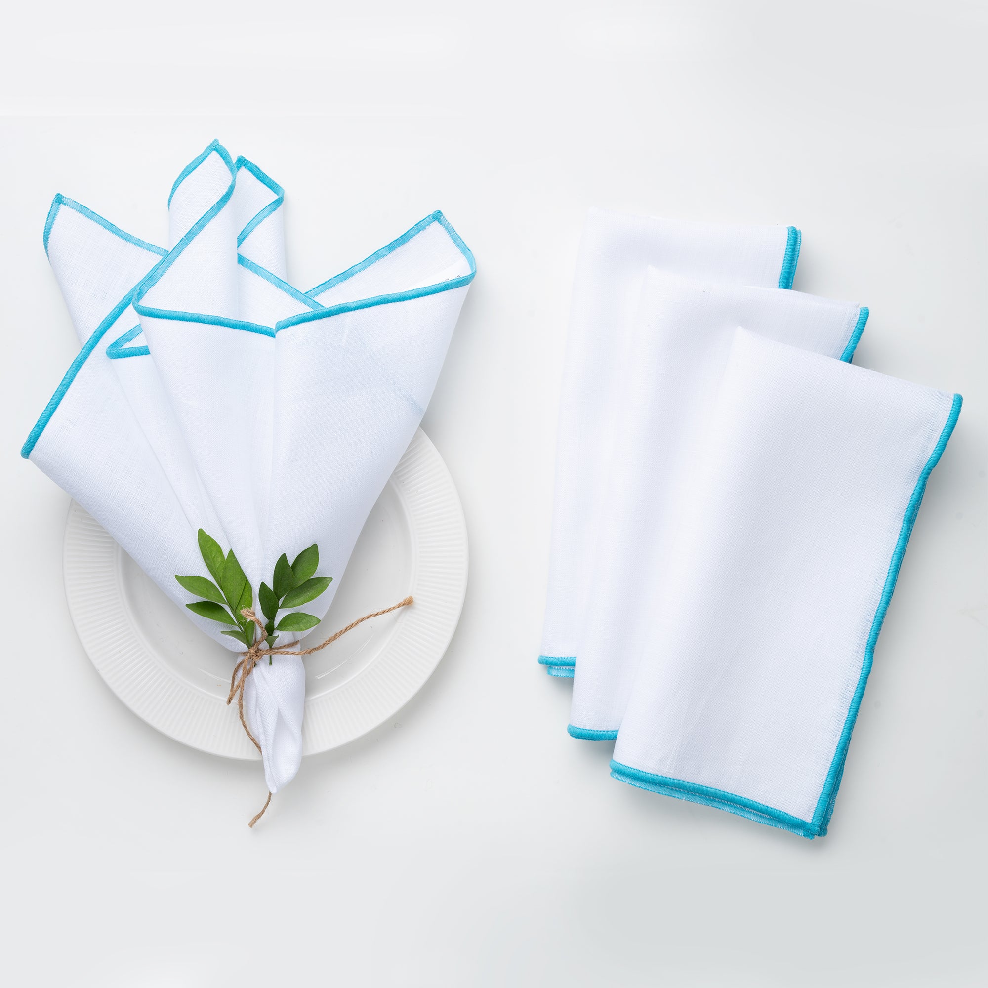 White and blue pure linen dinner napkins styled on a dining table
