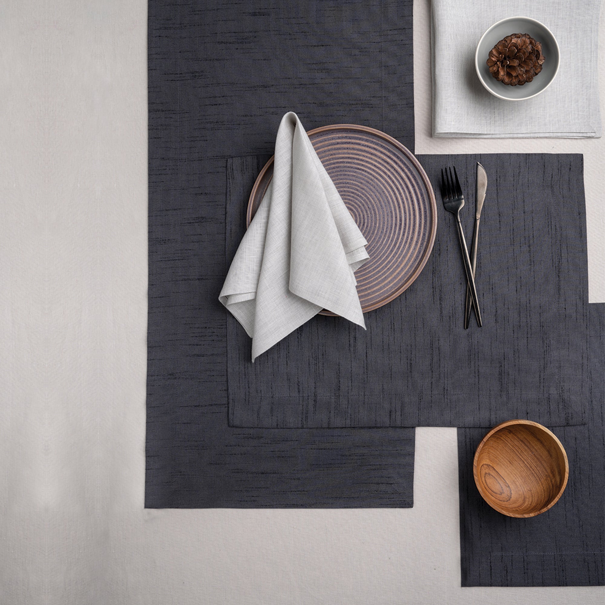 Charcoal grey Luxe Shine table runner with matching D'Moksha table linens