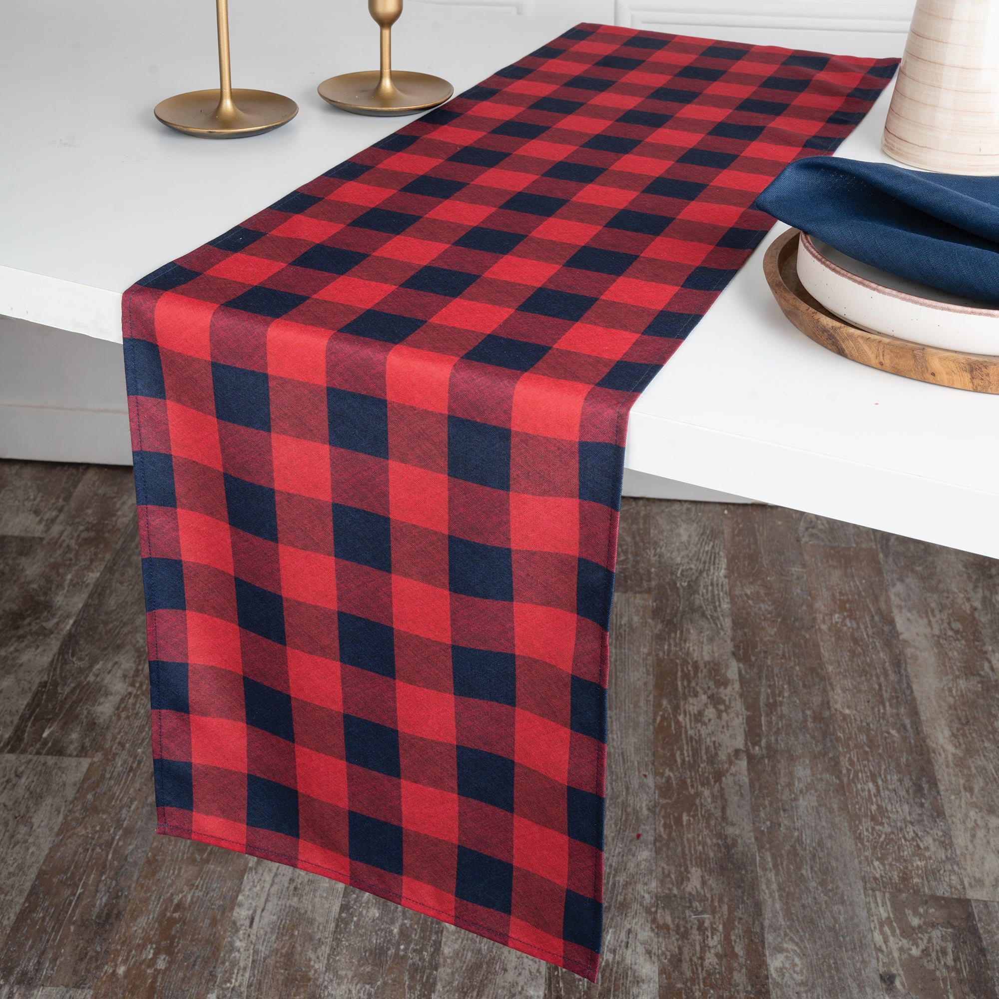 Red and navy blue linen table runner styled on a dining table