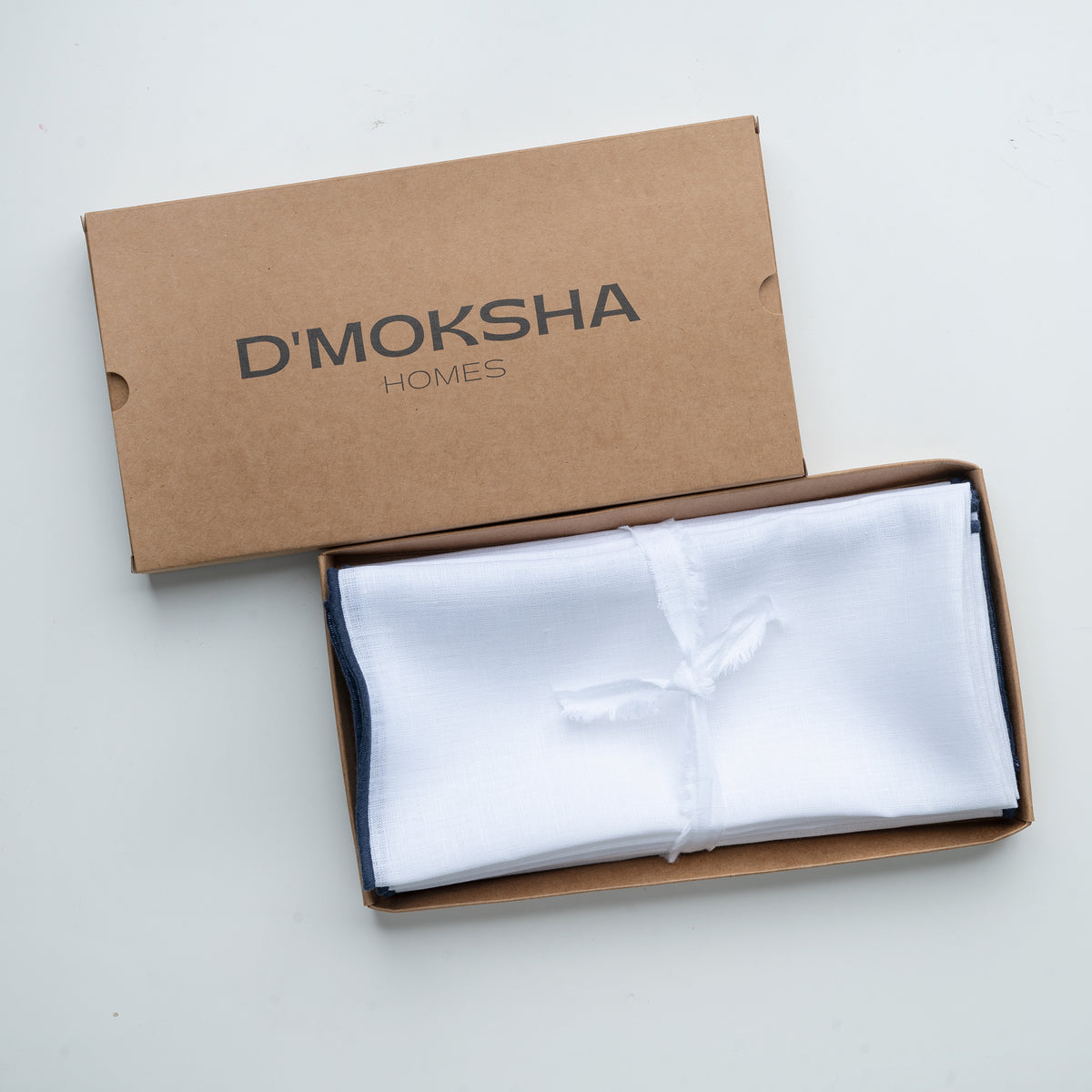 White and navy blue pure linen dinner napkins in a set table setting