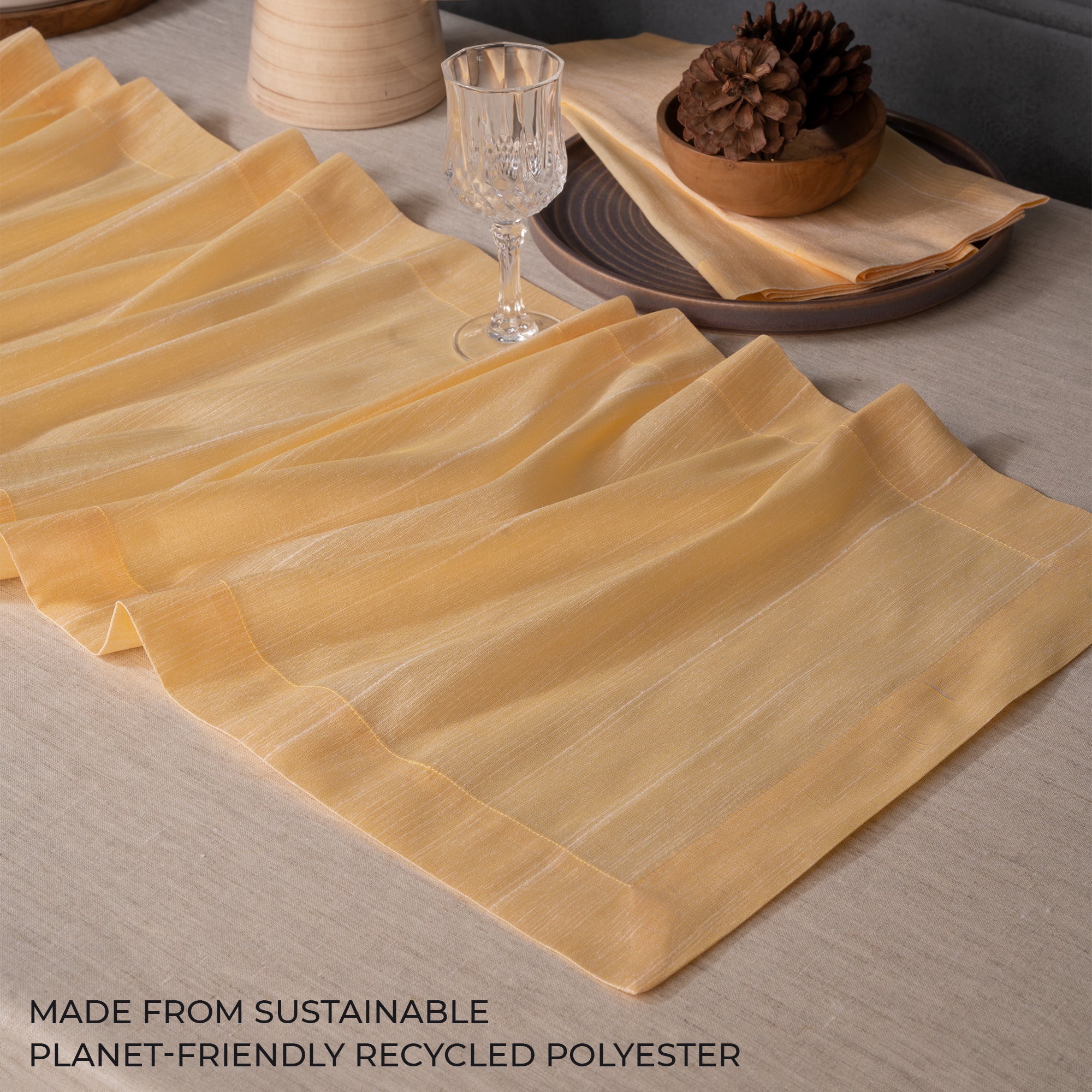 Close-up of the mitered corners on a cream Luxe Shine table runner