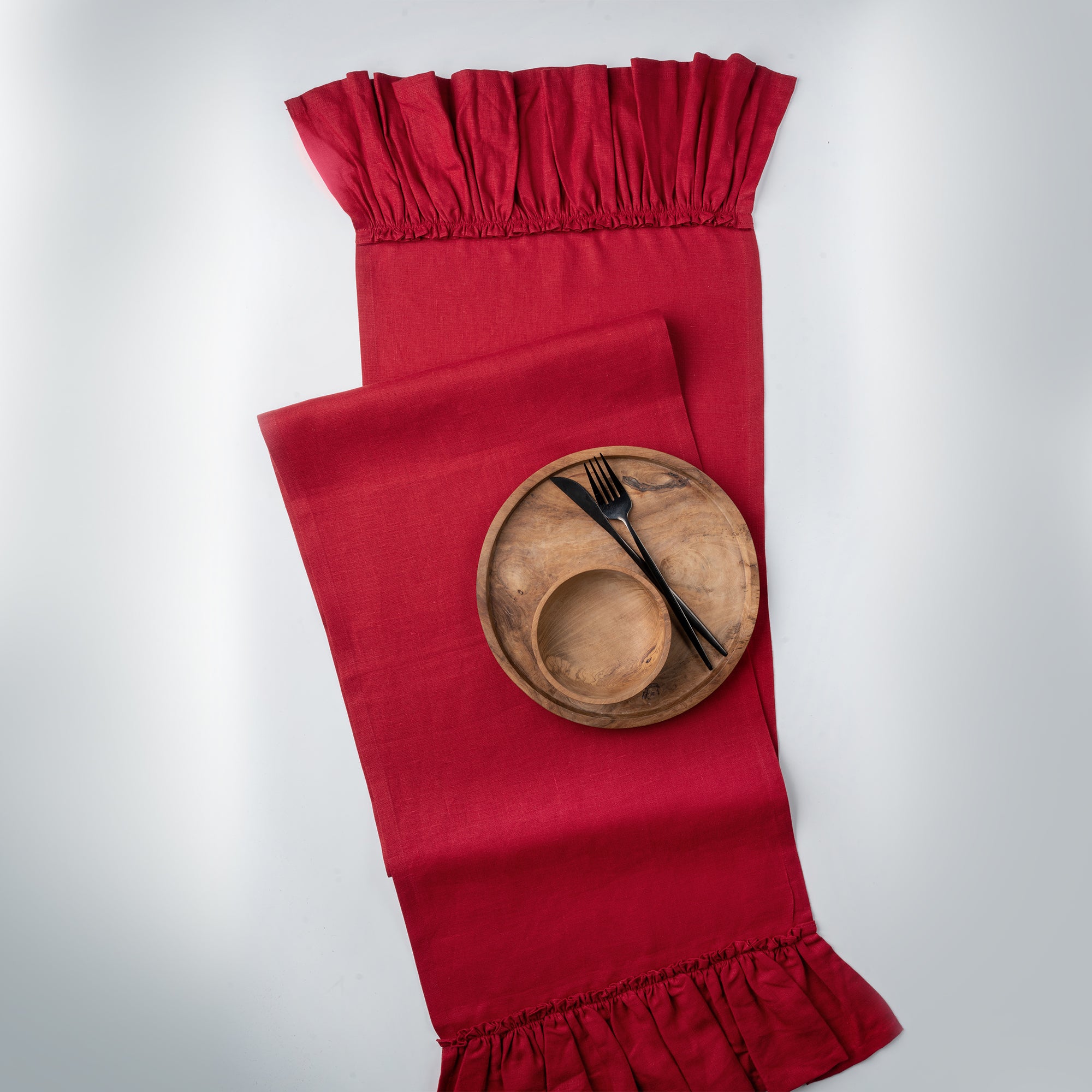 Red pure linen table runner folded to show fabric texture