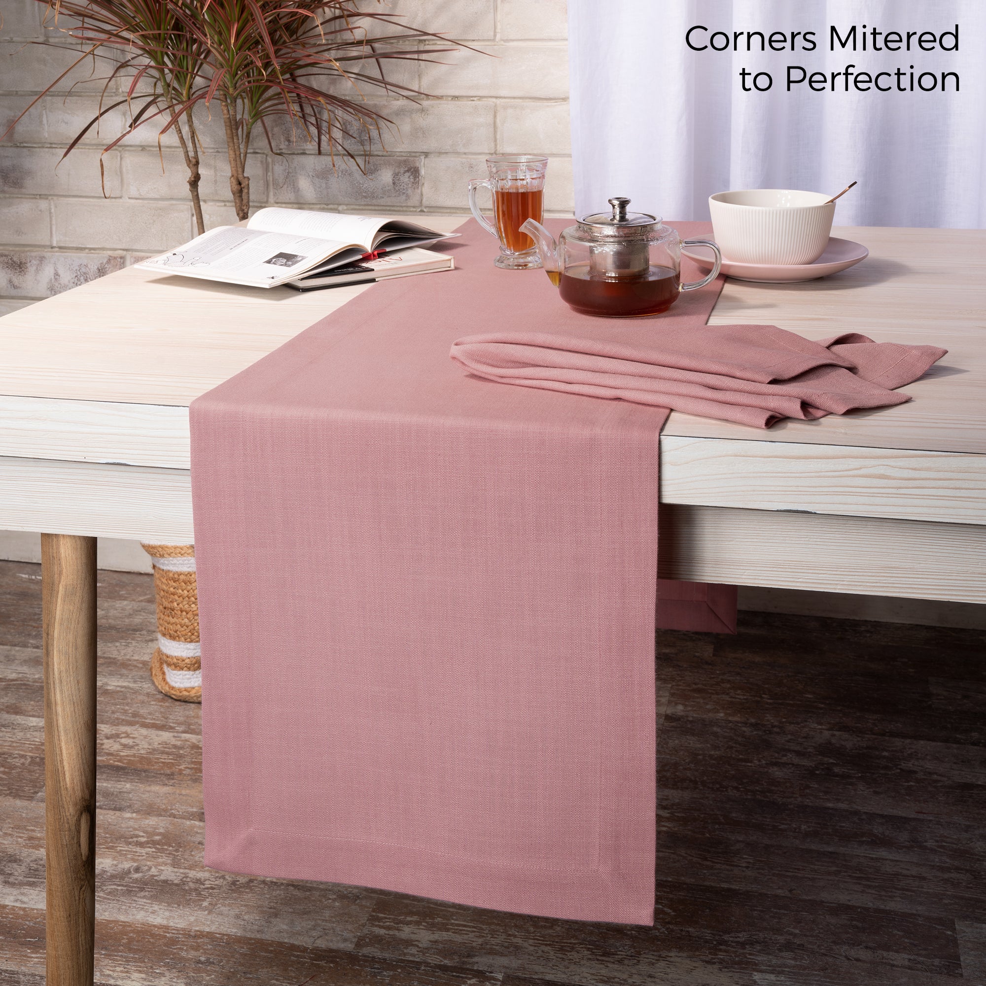 Dusty pink faux linen table runner styled on a dining table