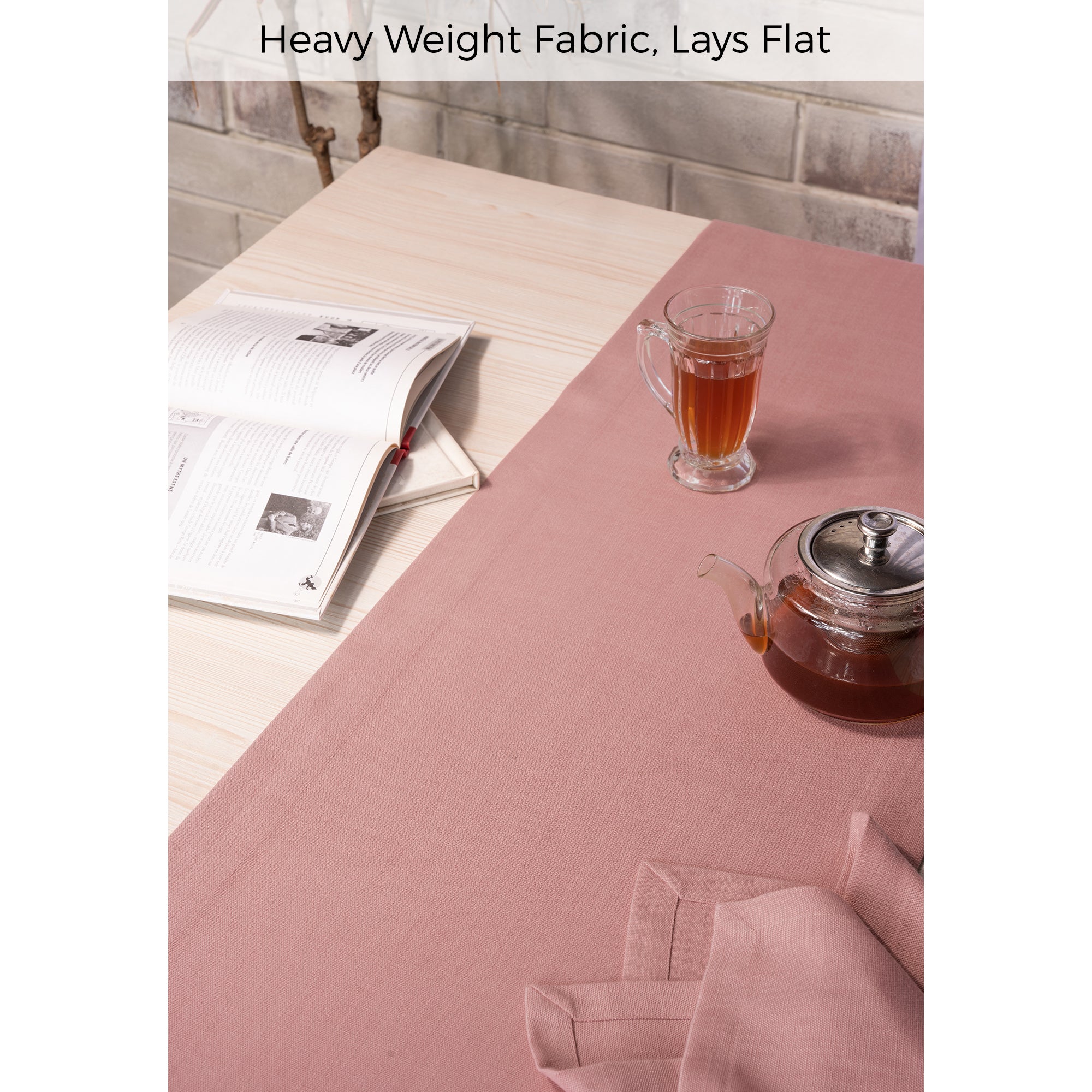 Close-up of the mitered corners on a dusty pink faux linen table runner