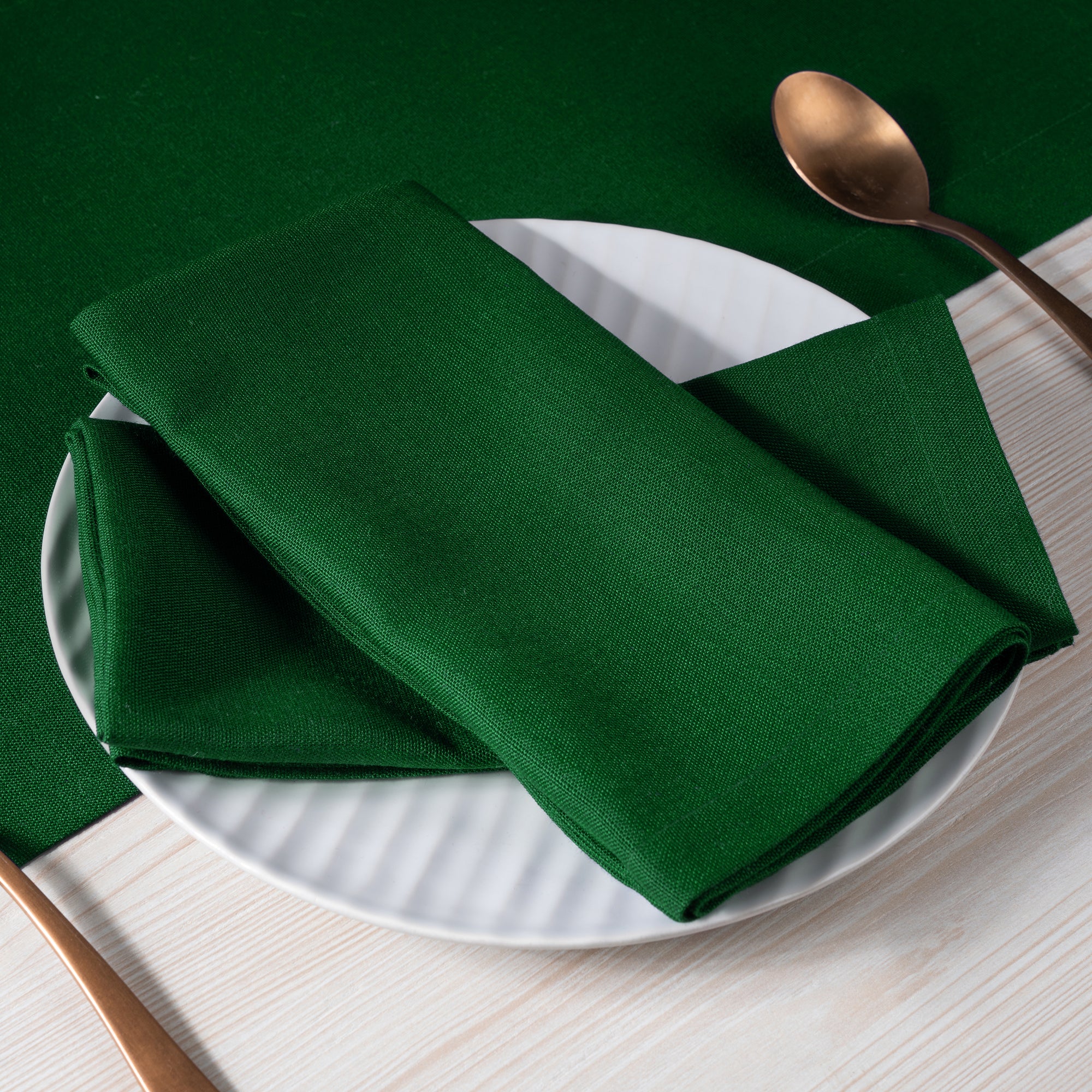 Eden green faux linen dinner napkins with matching D'Moksha table linens