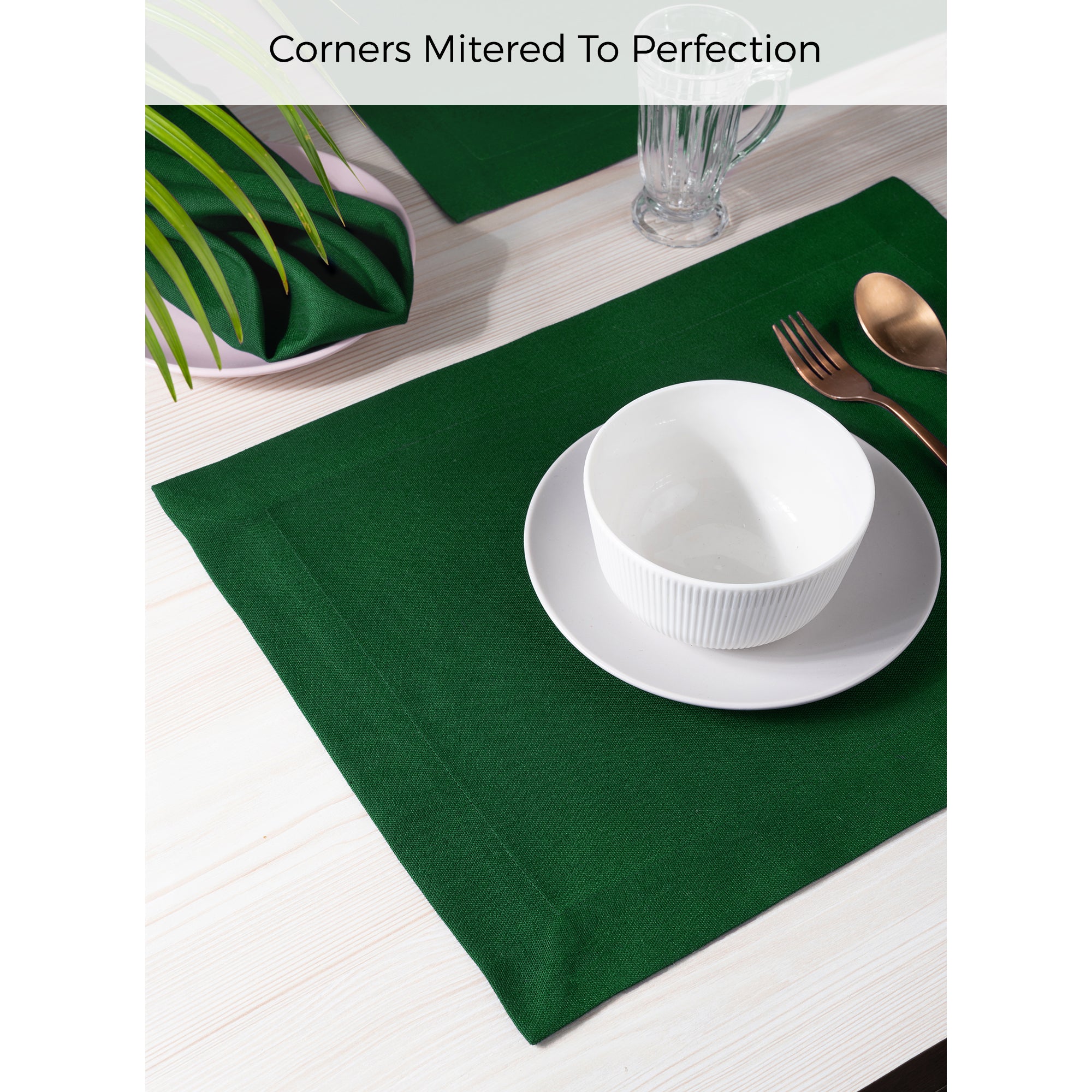 Eden green faux linen placemats styled on a dining table