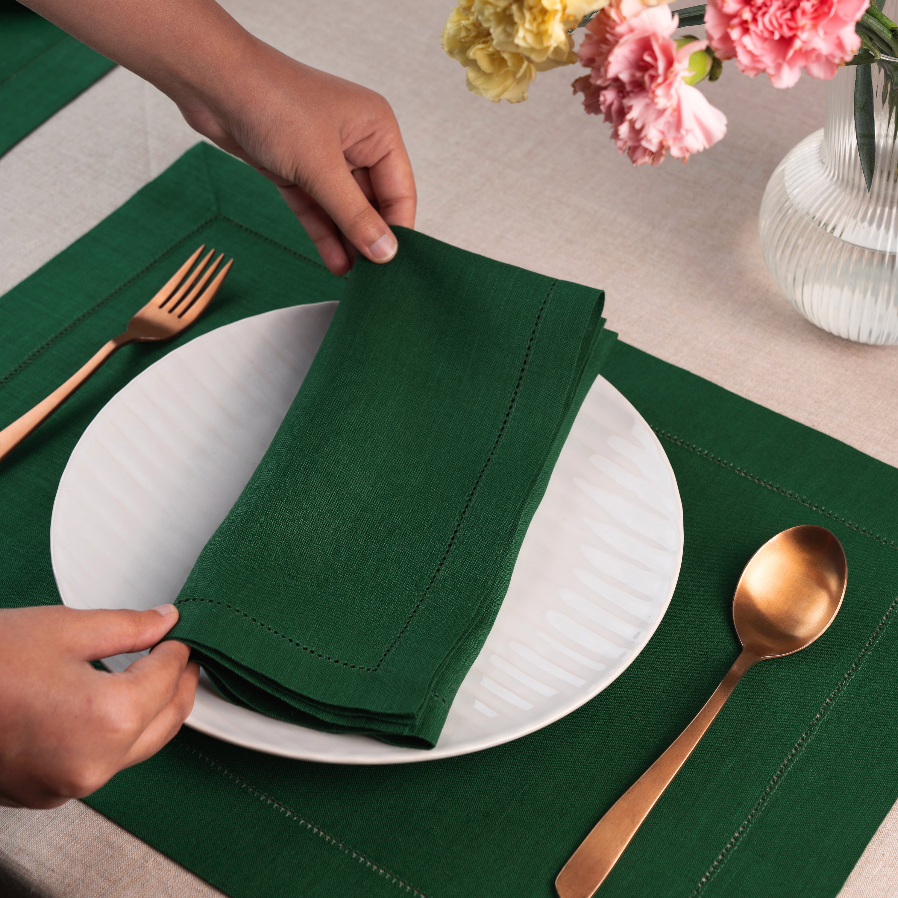 Forest green pure linen dinner napkins styled on a dining table