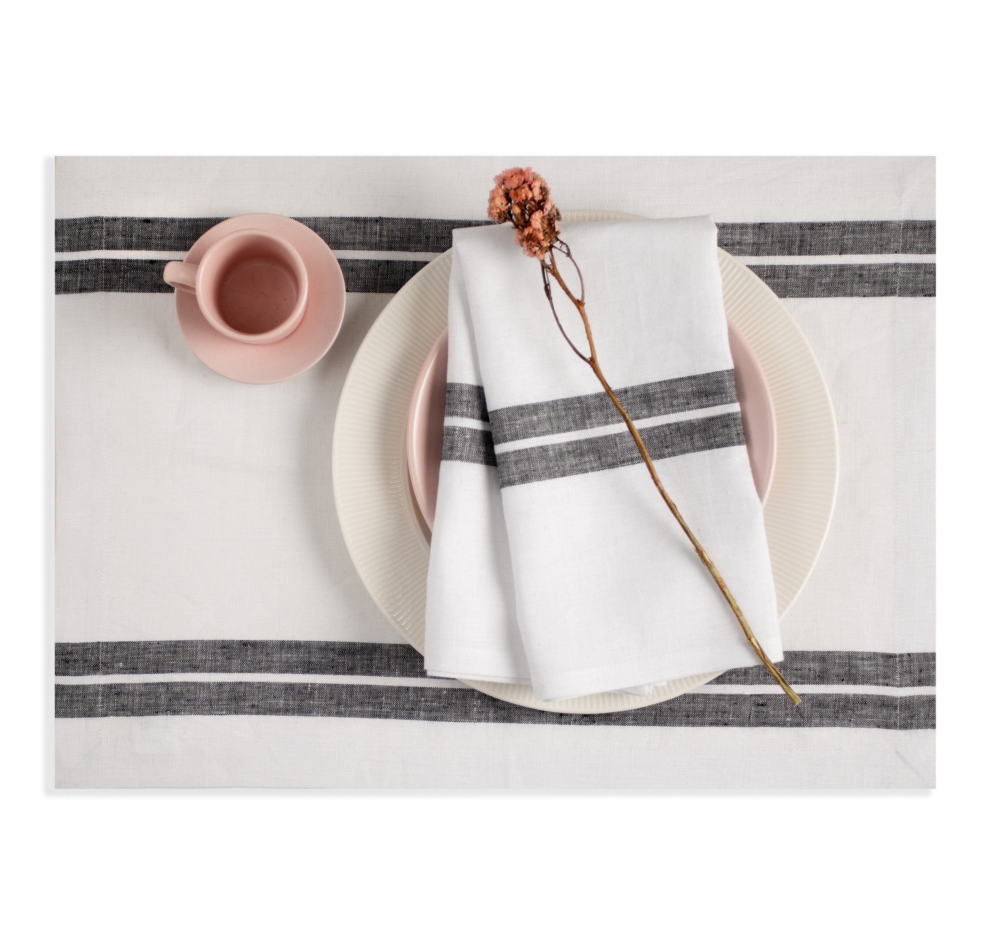 White and black pure linen dinner napkins styled on a dining table