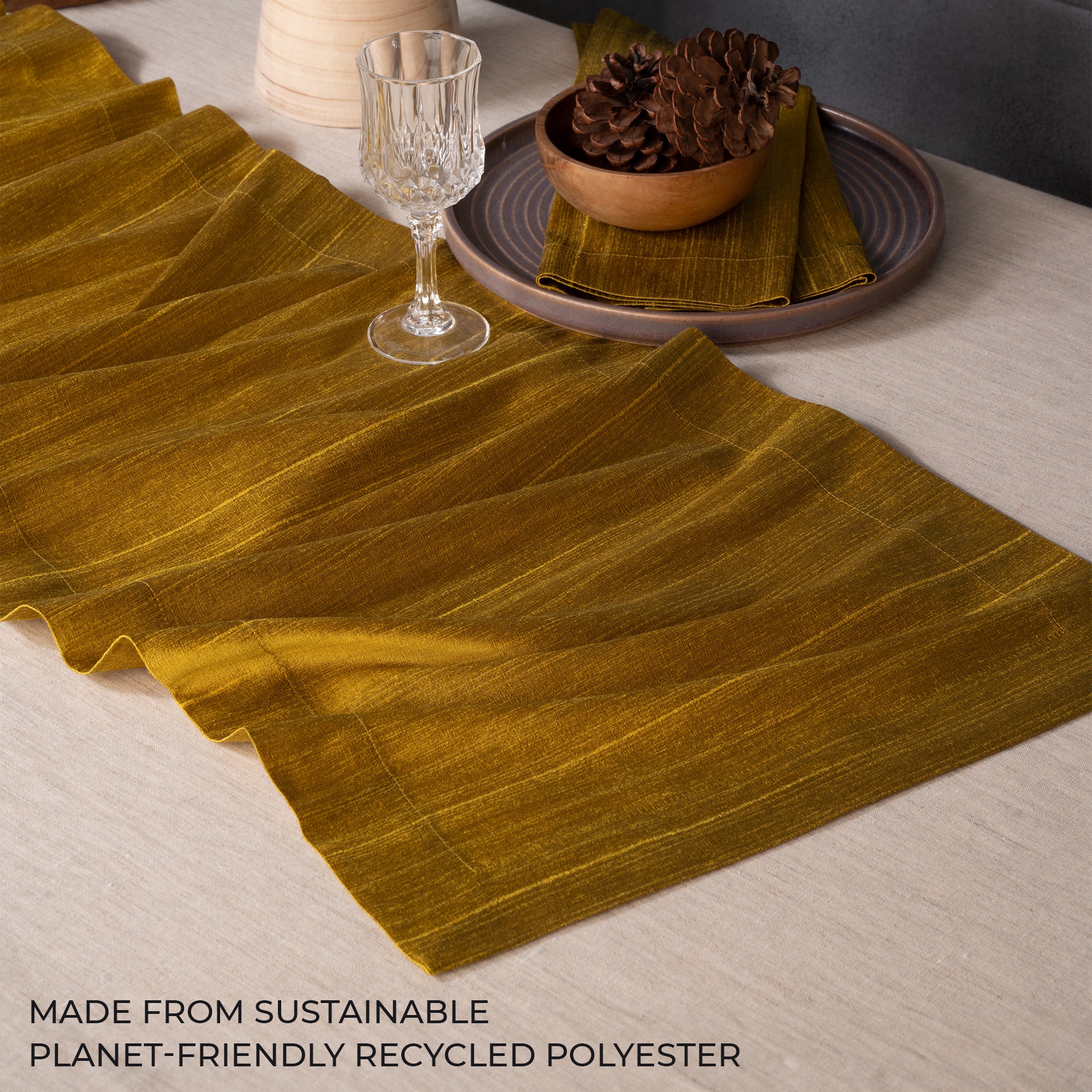 Close-up of the mitered corners on a gold Luxe Shine table runner