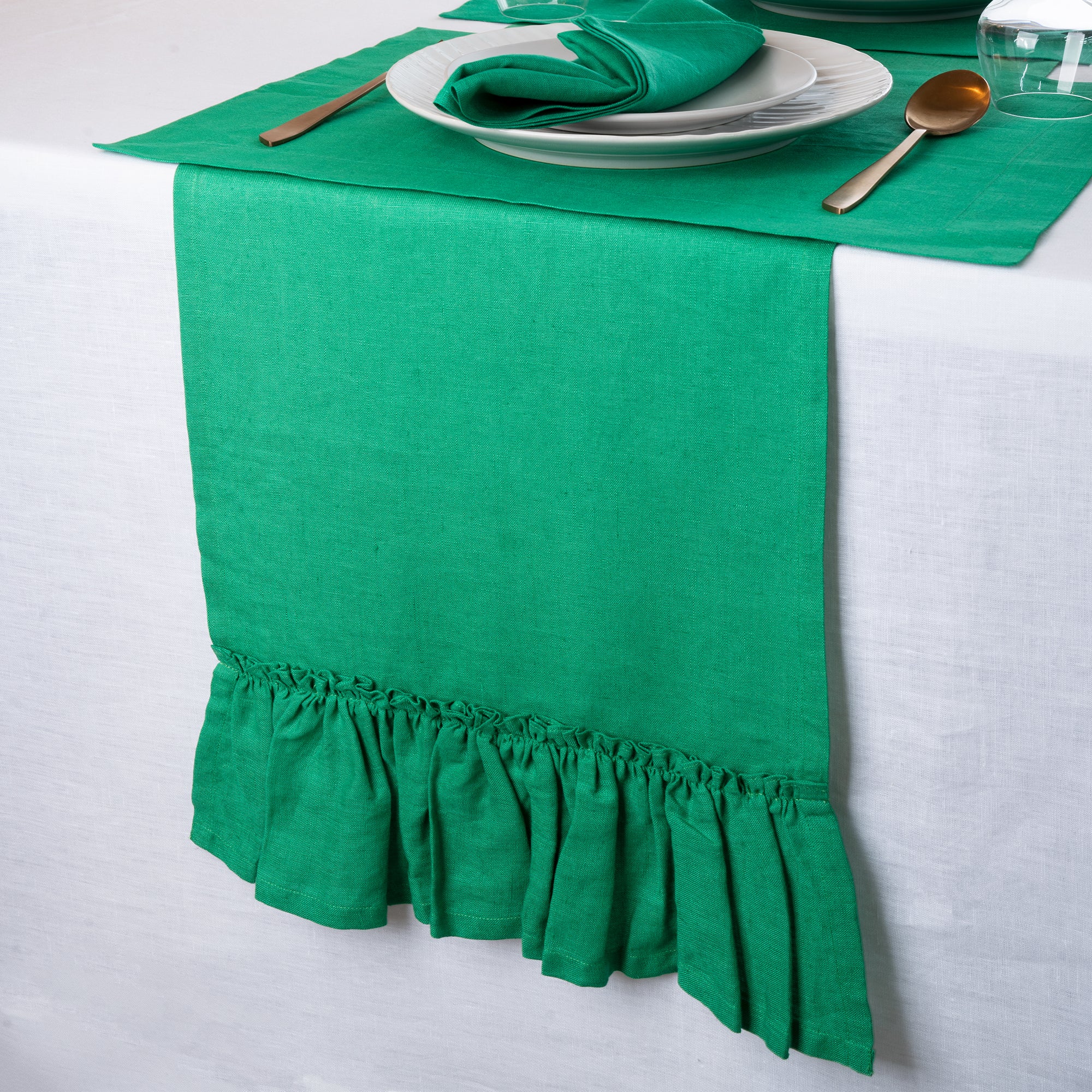 Close-up of the ruffled edge on a kelly green pure linen table runner