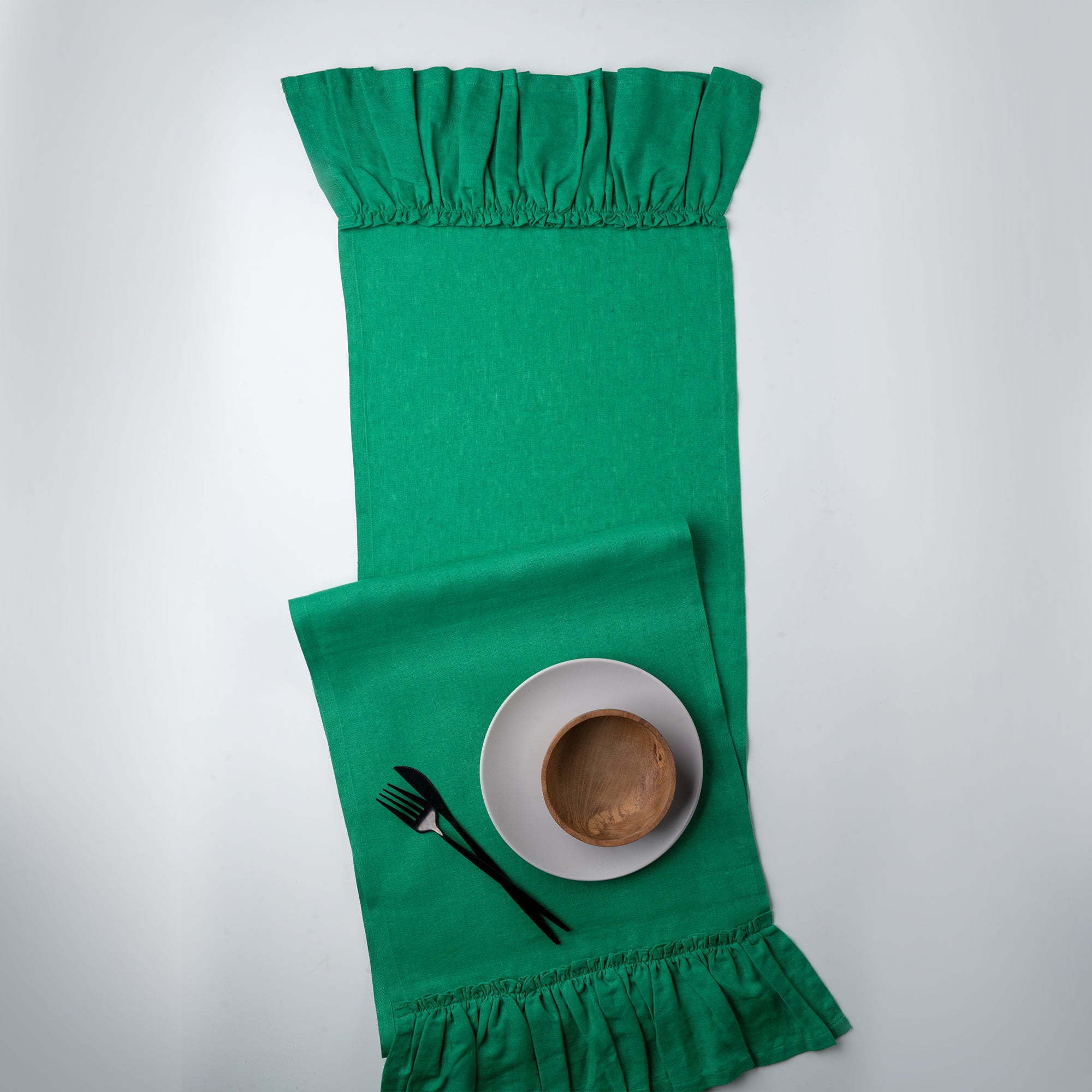 Kelly green pure linen table runner in a set table setting