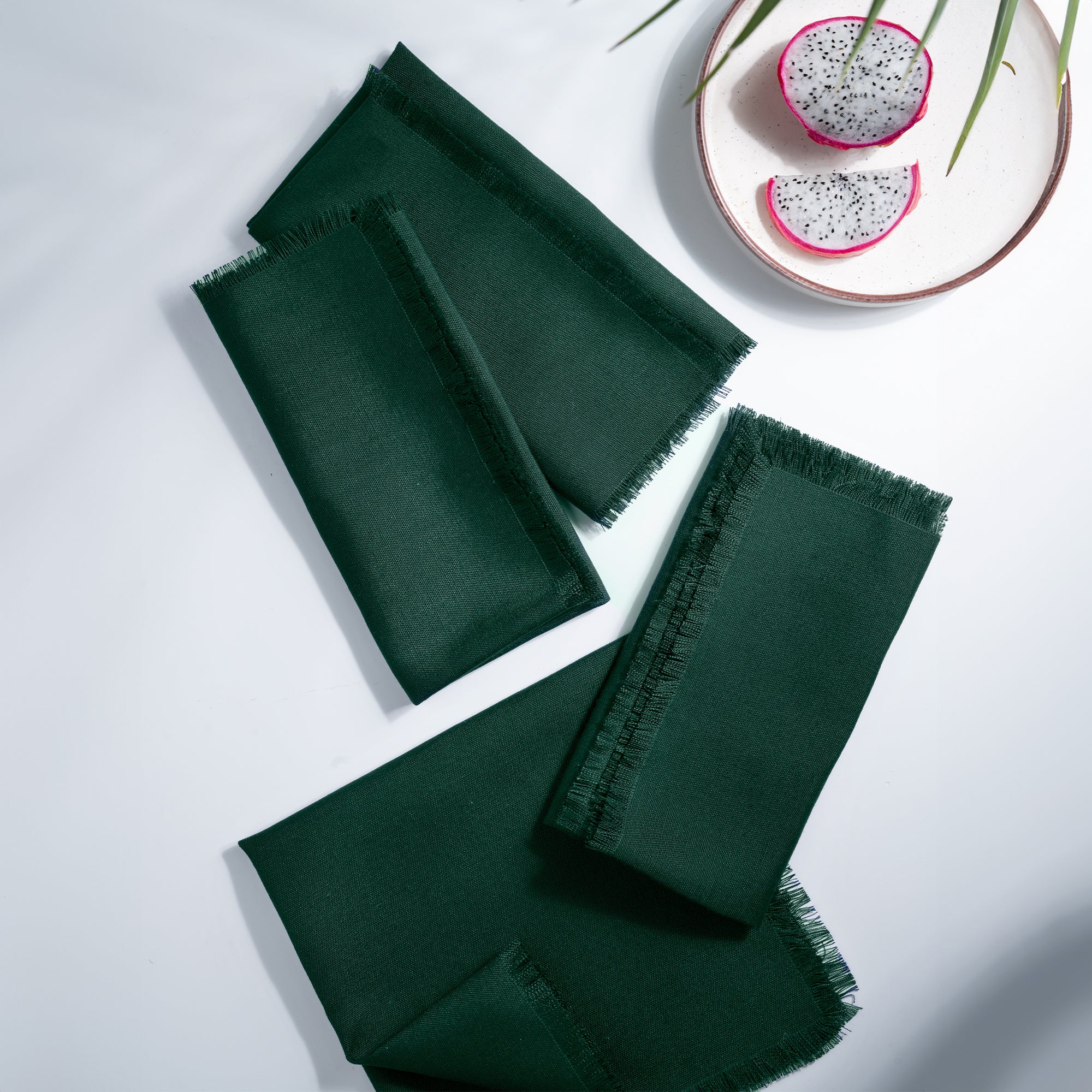 Eden green faux linen dinner napkins styled on a dining table