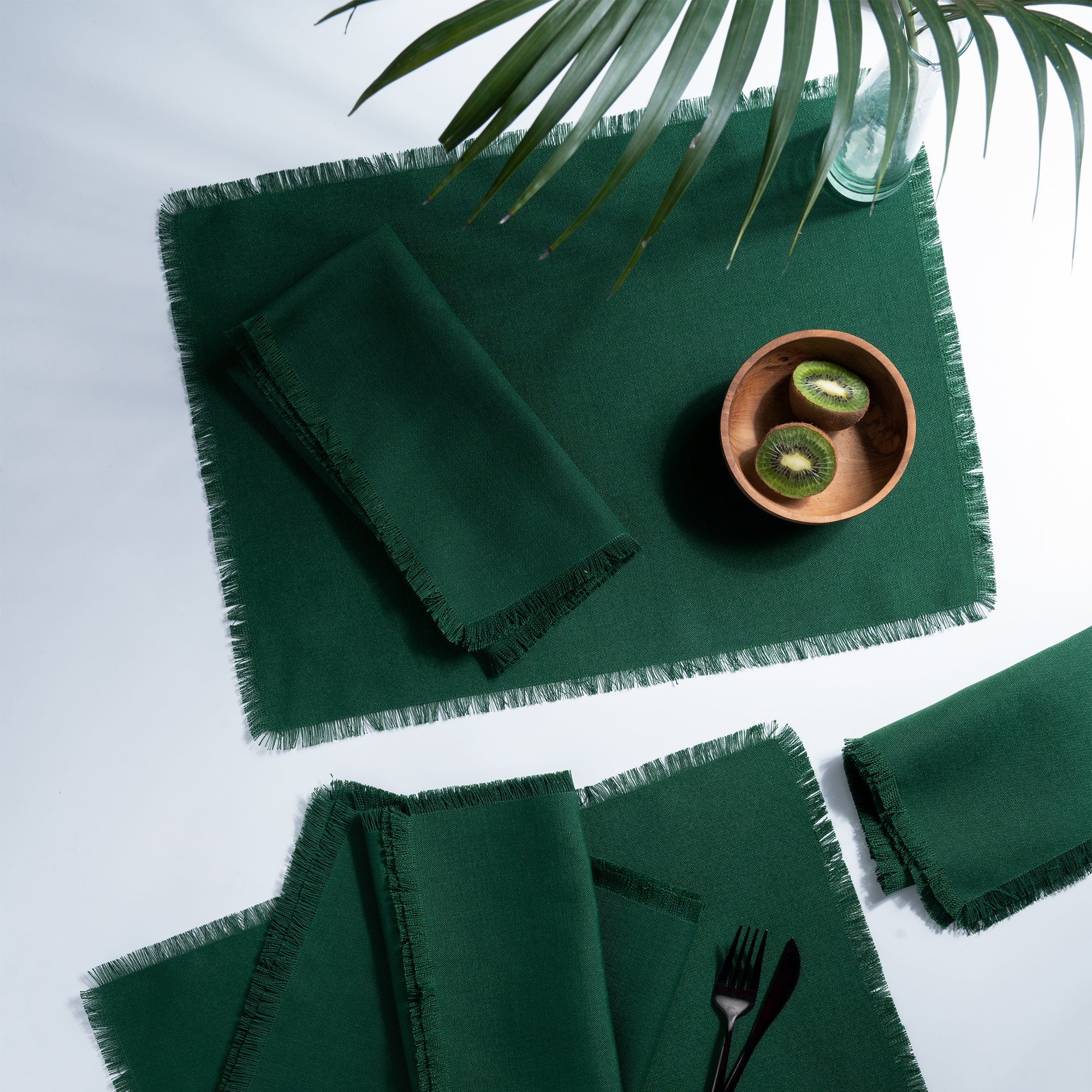 Eden green faux linen placemats styled on a dining table