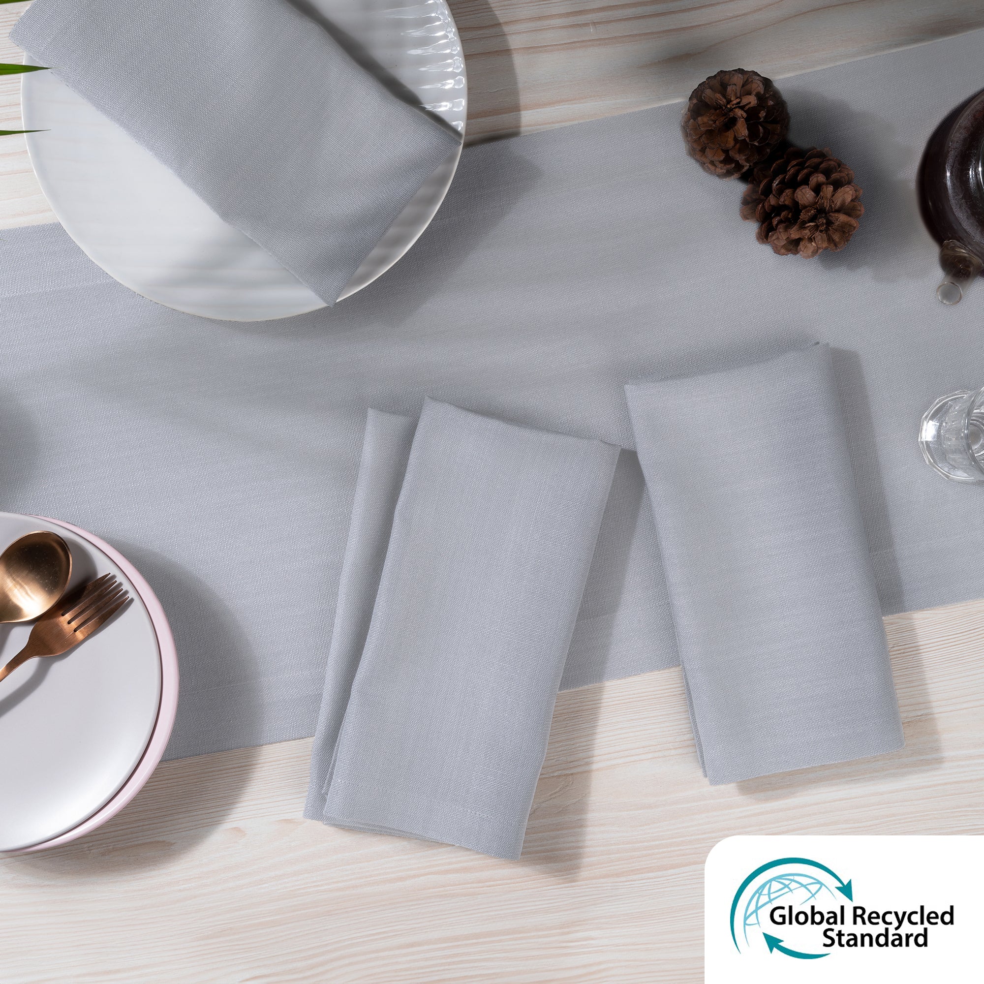 Light grey faux linen dinner napkins styled on a dining table