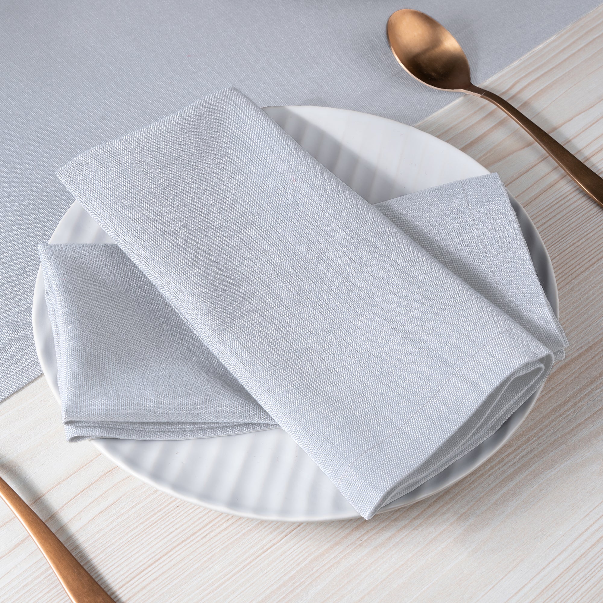 Light grey faux linen dinner napkins with matching D'Moksha table linens