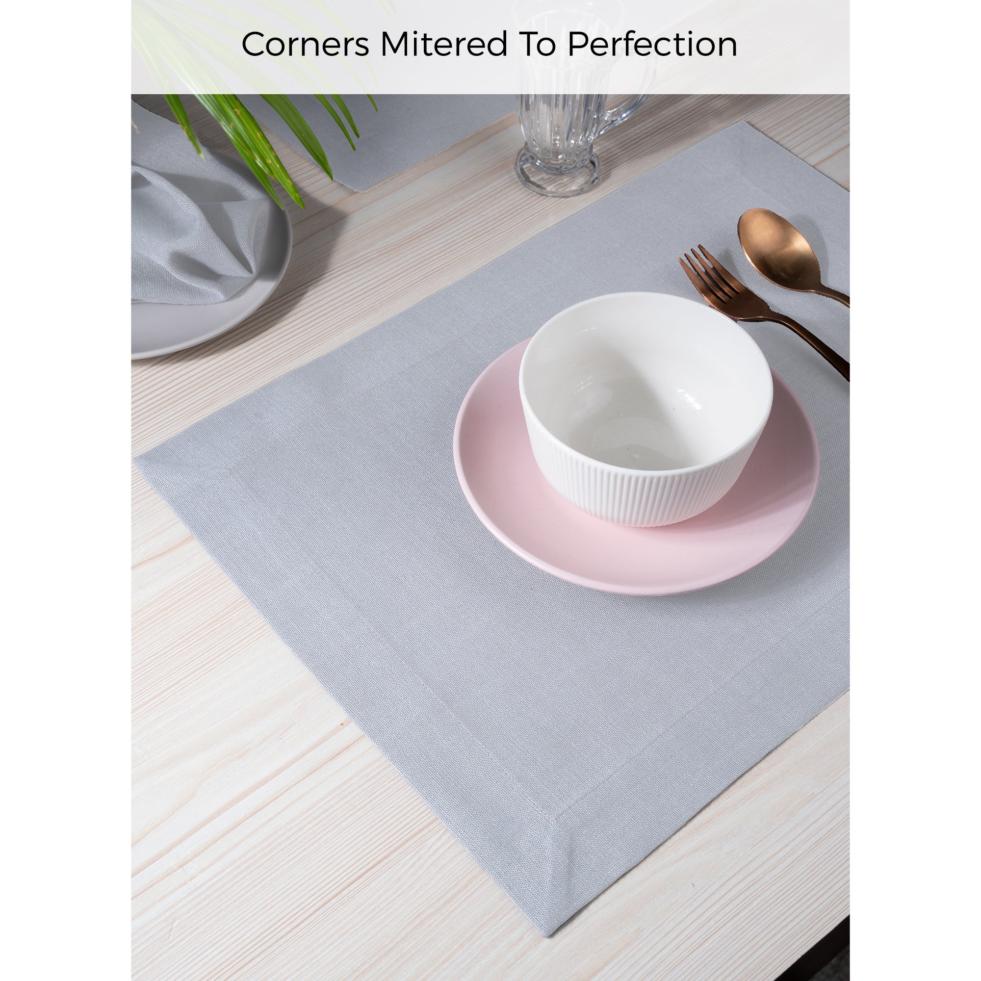 Light grey faux linen placemats styled on a dining table