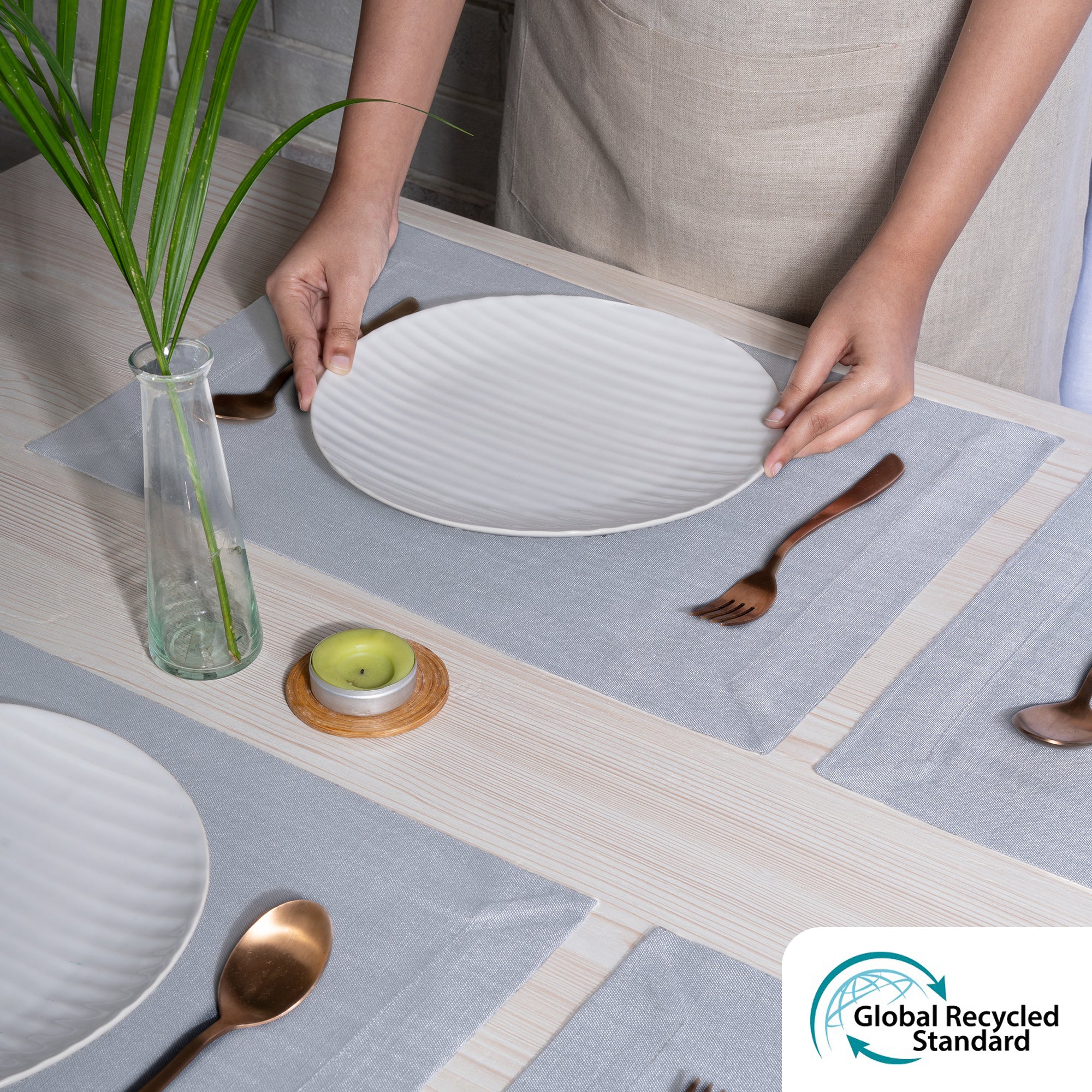 Close-up of the mitered corners on light grey faux linen placemats