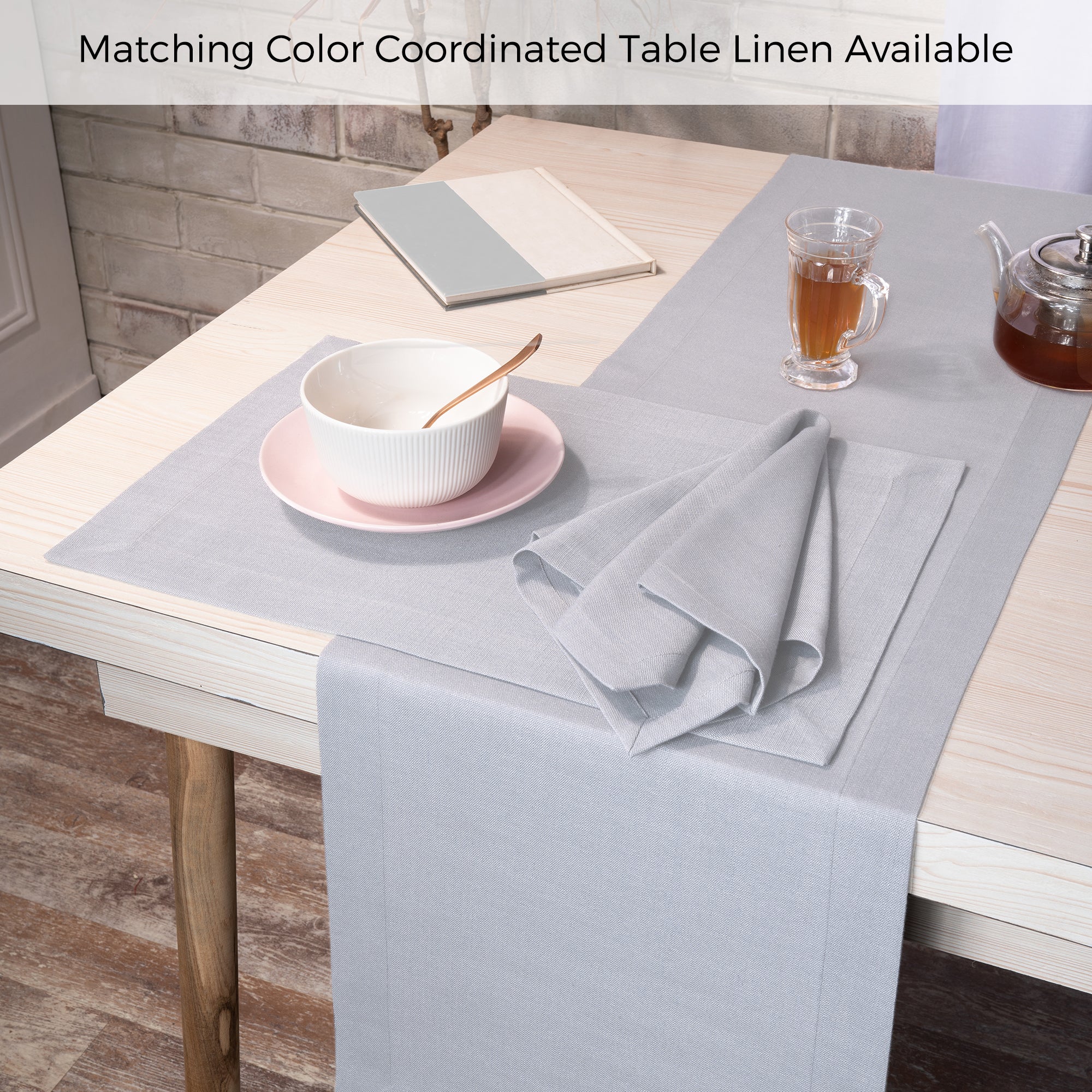Light grey faux linen placemats folded to show fabric texture