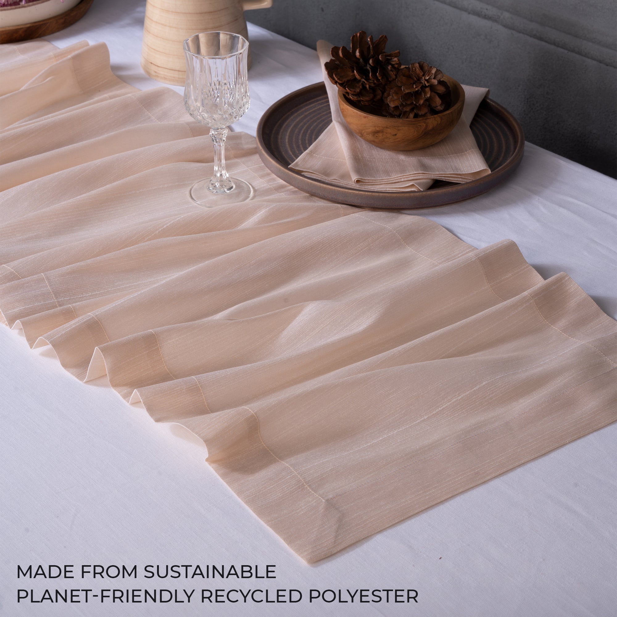 Close-up of the mitered corners on a light natural Luxe Shine table runner