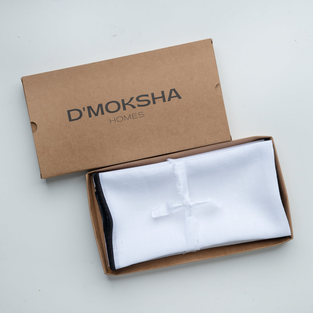 White and black pure linen dinner napkins in a set table setting