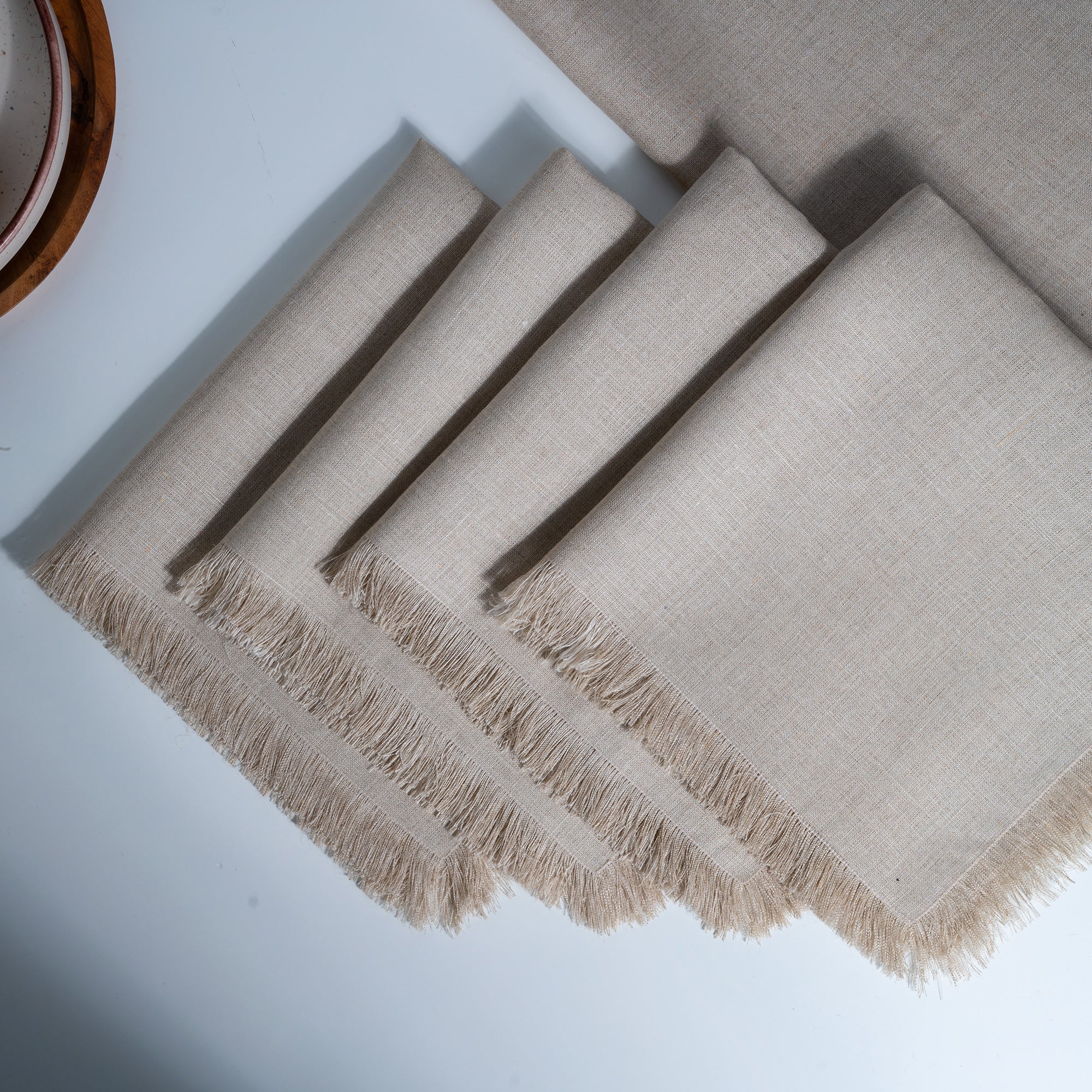 Natural pure linen dinner napkins styled on a dining table