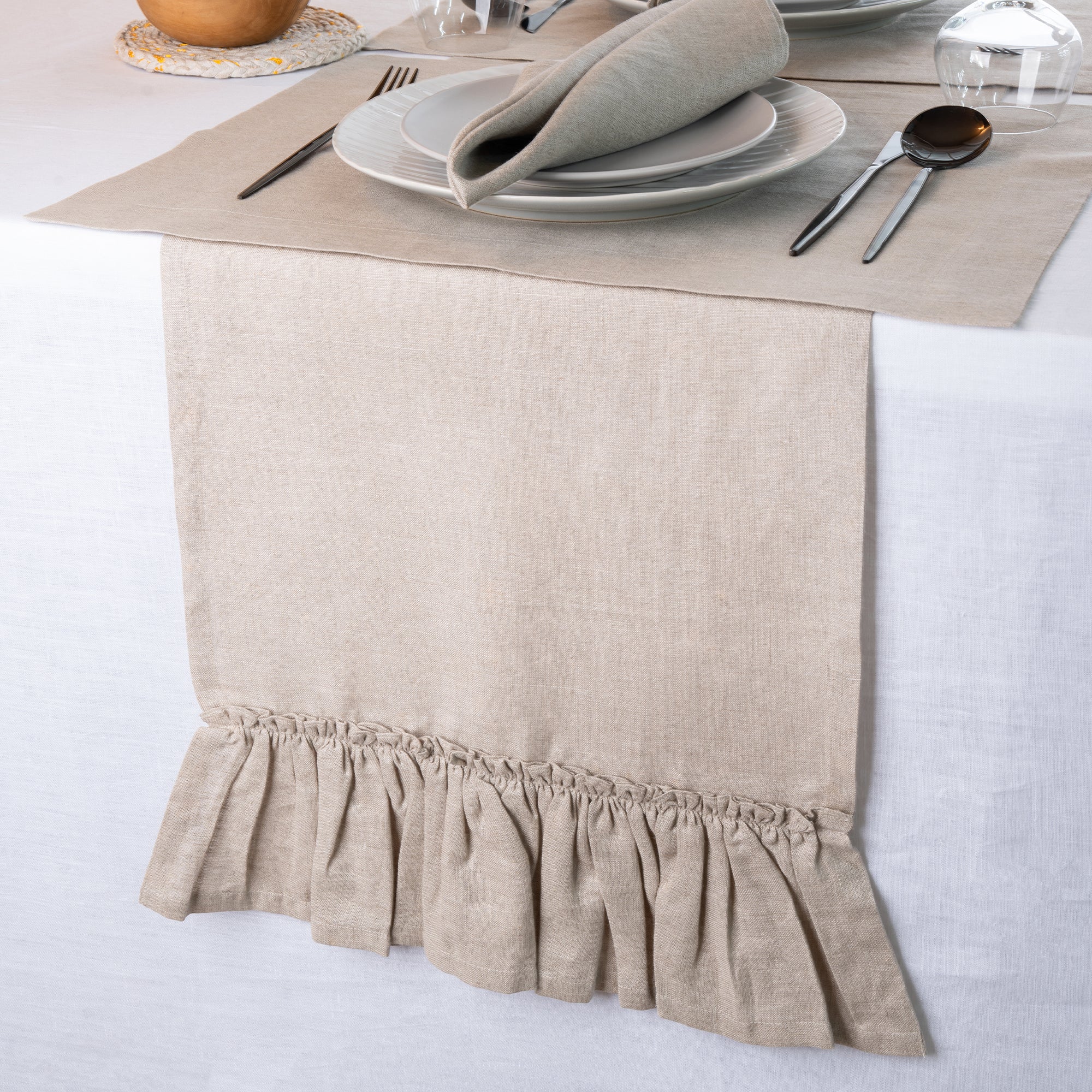 Close-up of the ruffled edge on a natural pure linen table runner