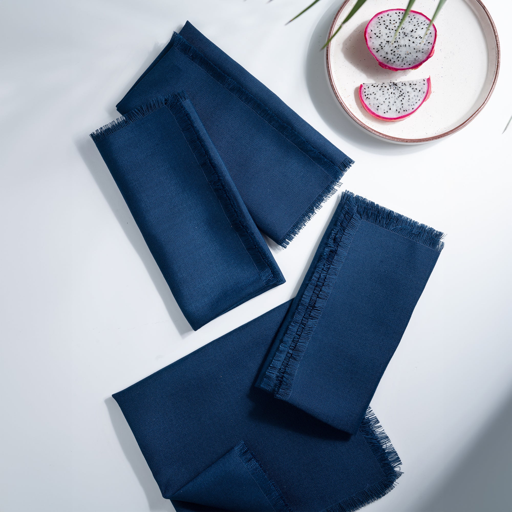 Navy blue faux linen dinner napkins styled on a dining table