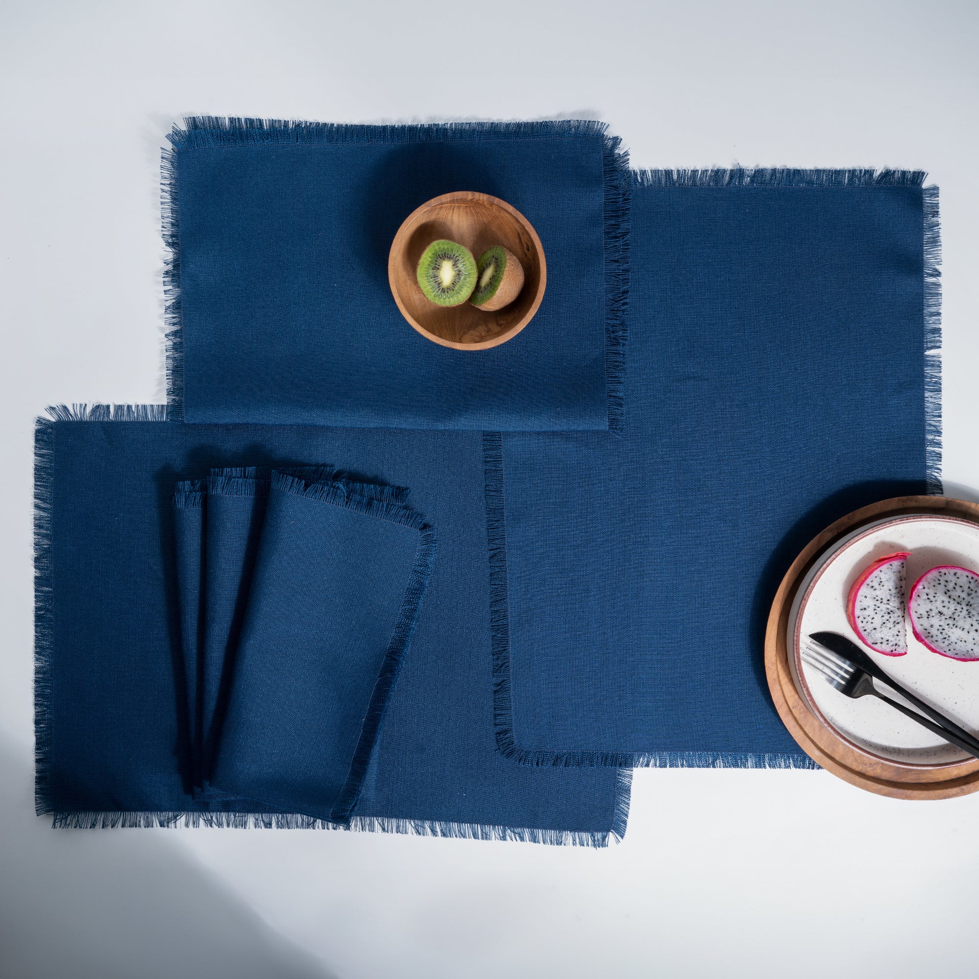 Close-up of the fringed edge on navy blue faux linen placemats