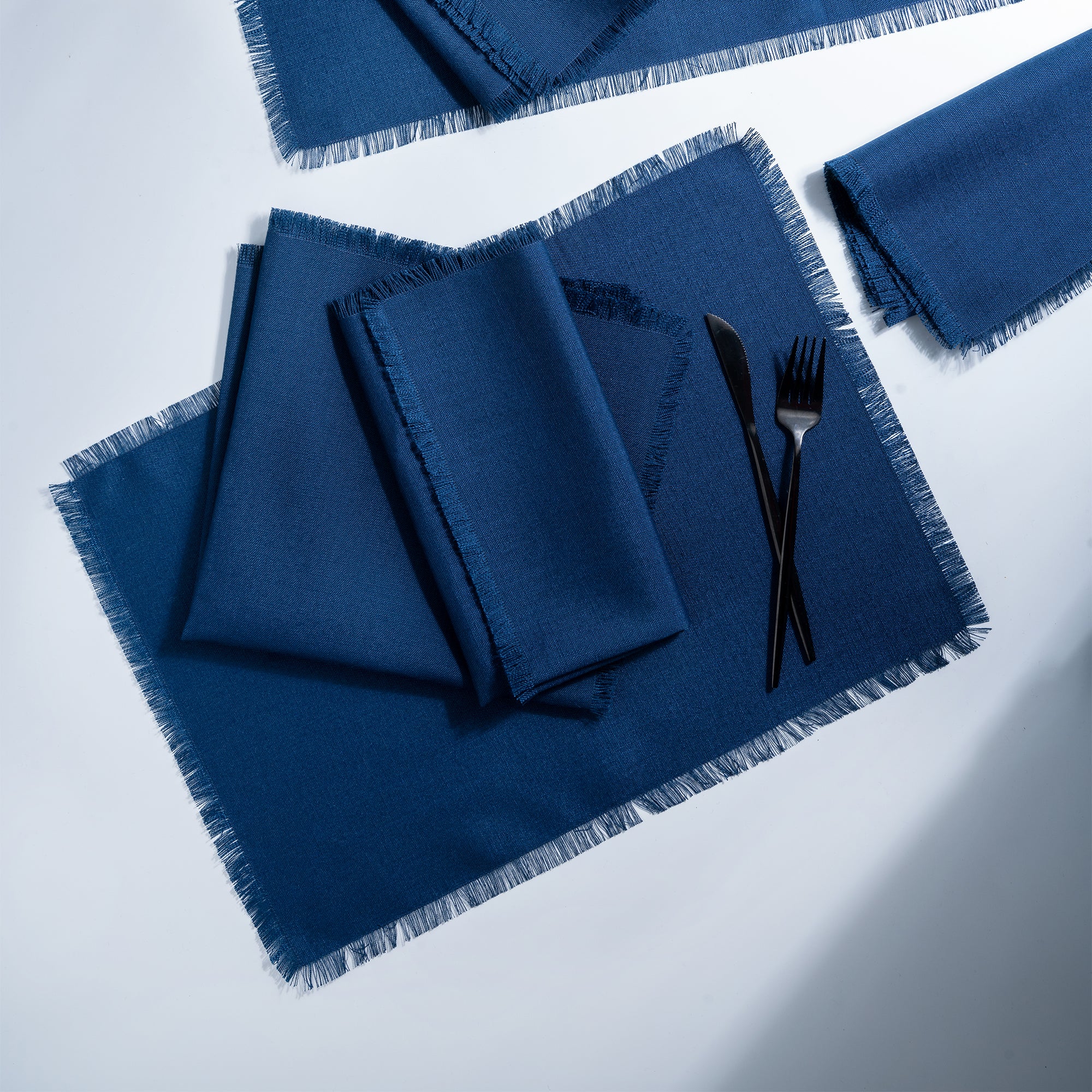 Navy blue faux linen placemats styled on a dining table