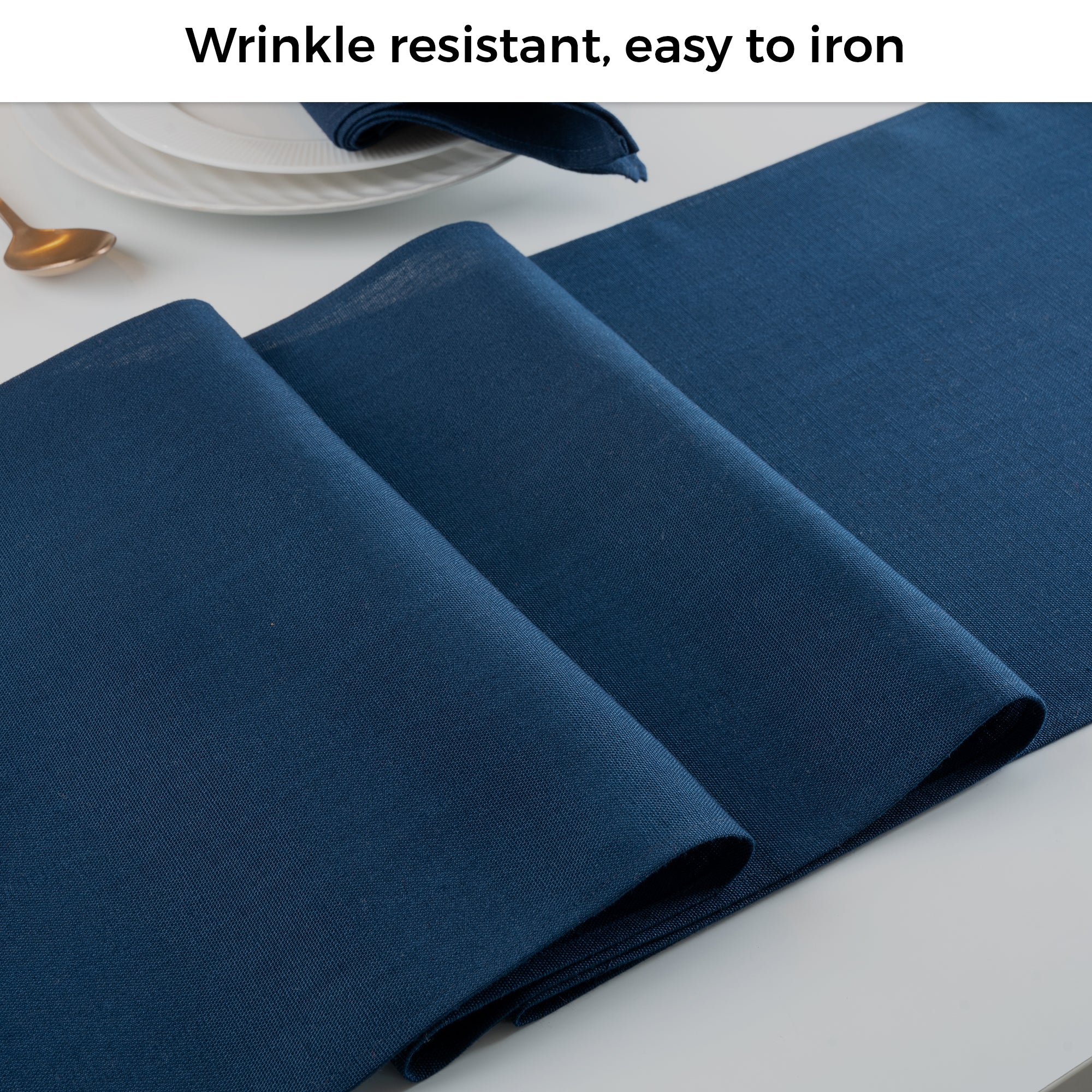 Navy blue faux linen table runner folded to show fabric texture