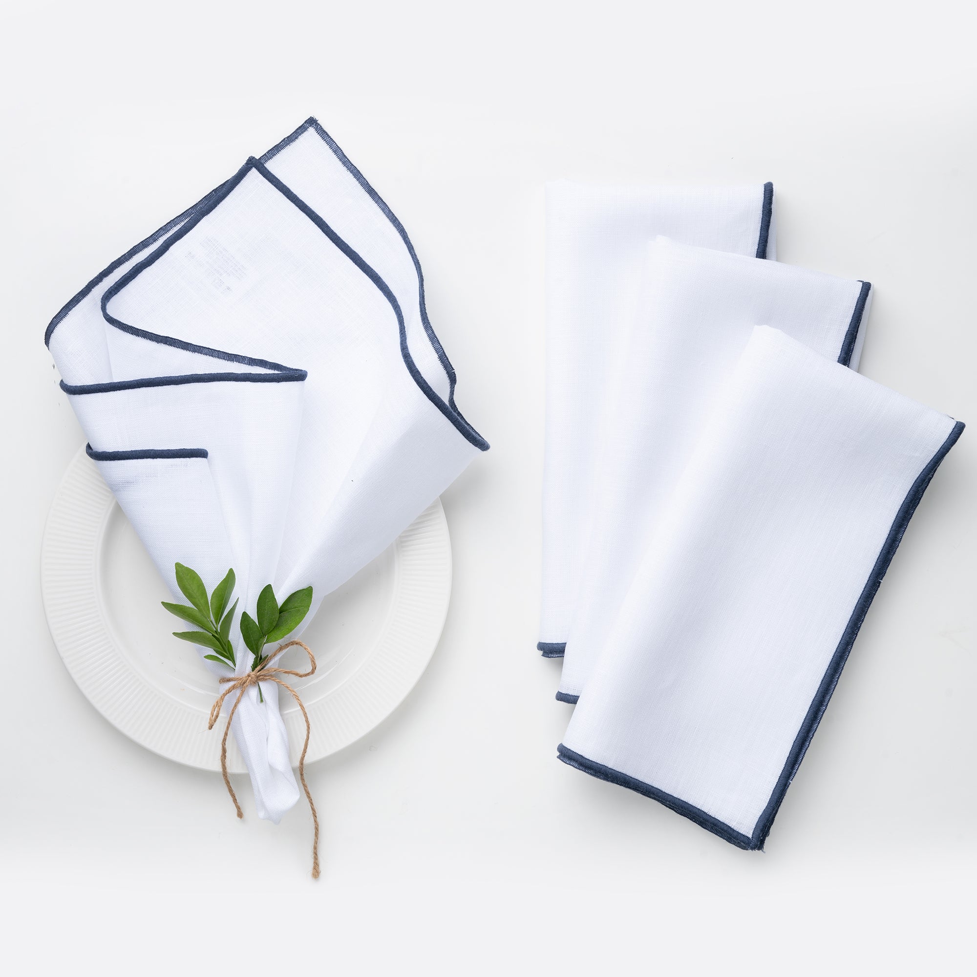 White and navy blue pure linen dinner napkins styled on a dining table